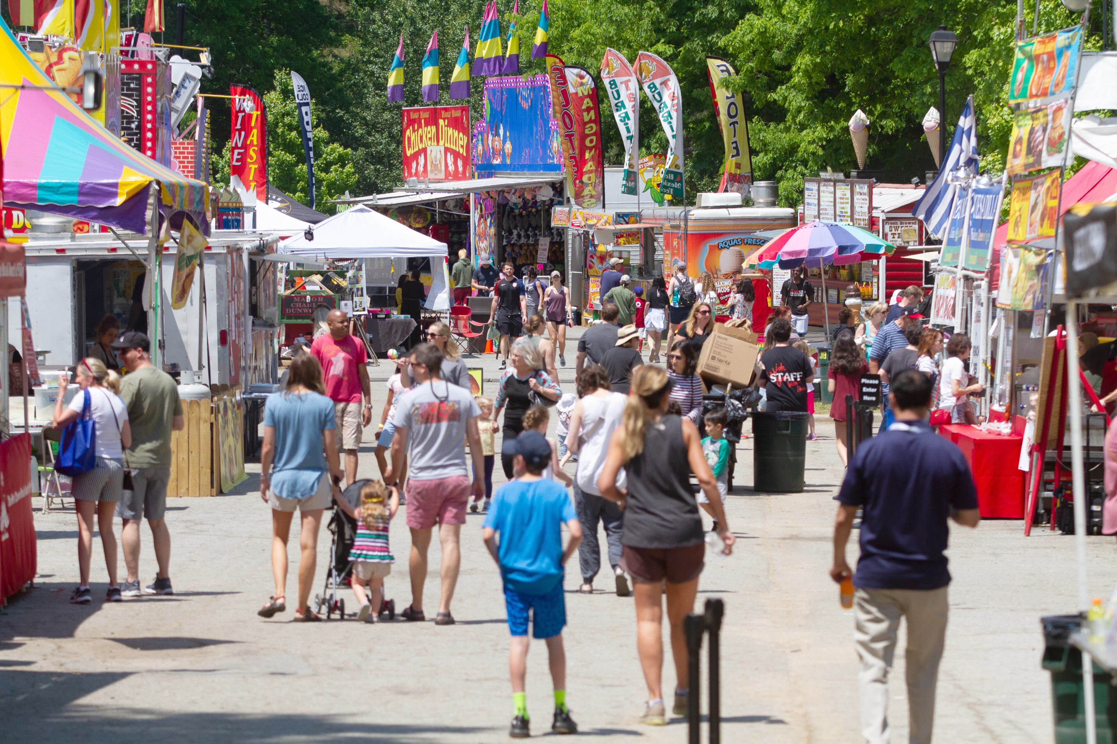 Fairgoers walk around the rides and food venues during the 20th annual Lemonade Days Festival on Sunday, April 28, 2019, in Dunwoody. Lemonade Days is the largest annual fundraising event for the Dunwoody Preservation Trust. All proceeds are used within the community for historic preservation and education. STEVE SCHAEFER / SPECIAL TO THE AJC