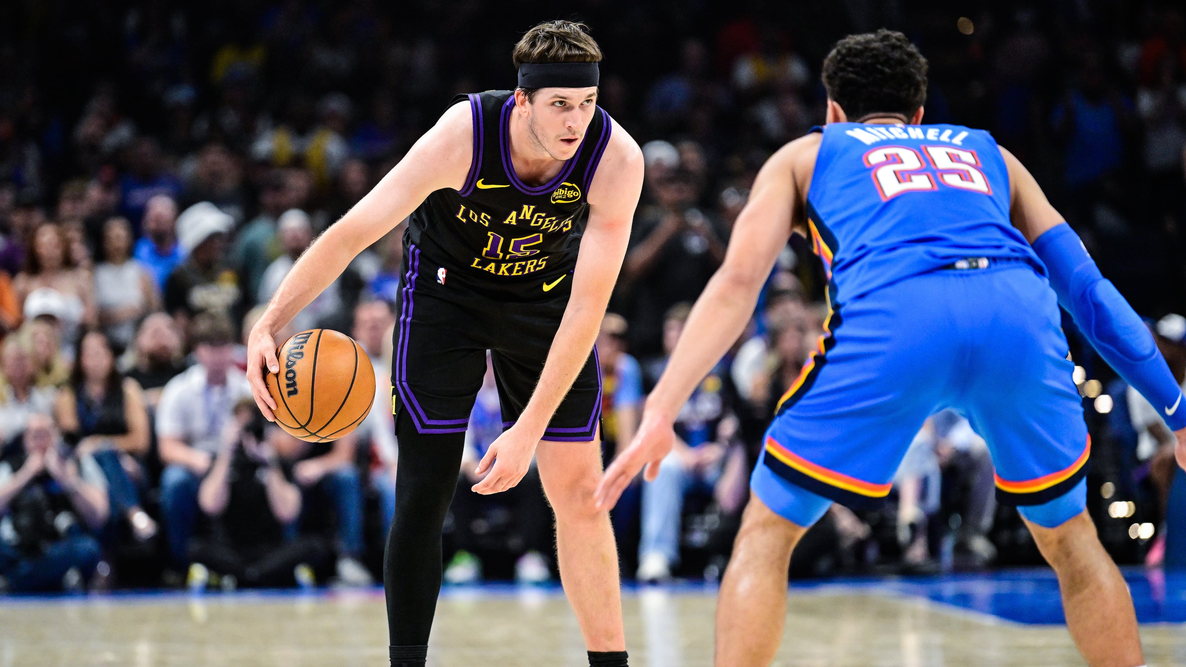 Los Angeles Lakers guard Austin Reaves (15) drives against Oklahoma City Thunder guard Ajay Mitchell (25) during the first half of an NBA basketball game Thursday, April. 2, 2026, in Oklahoma City. (AP Photo/Gerald Leong)