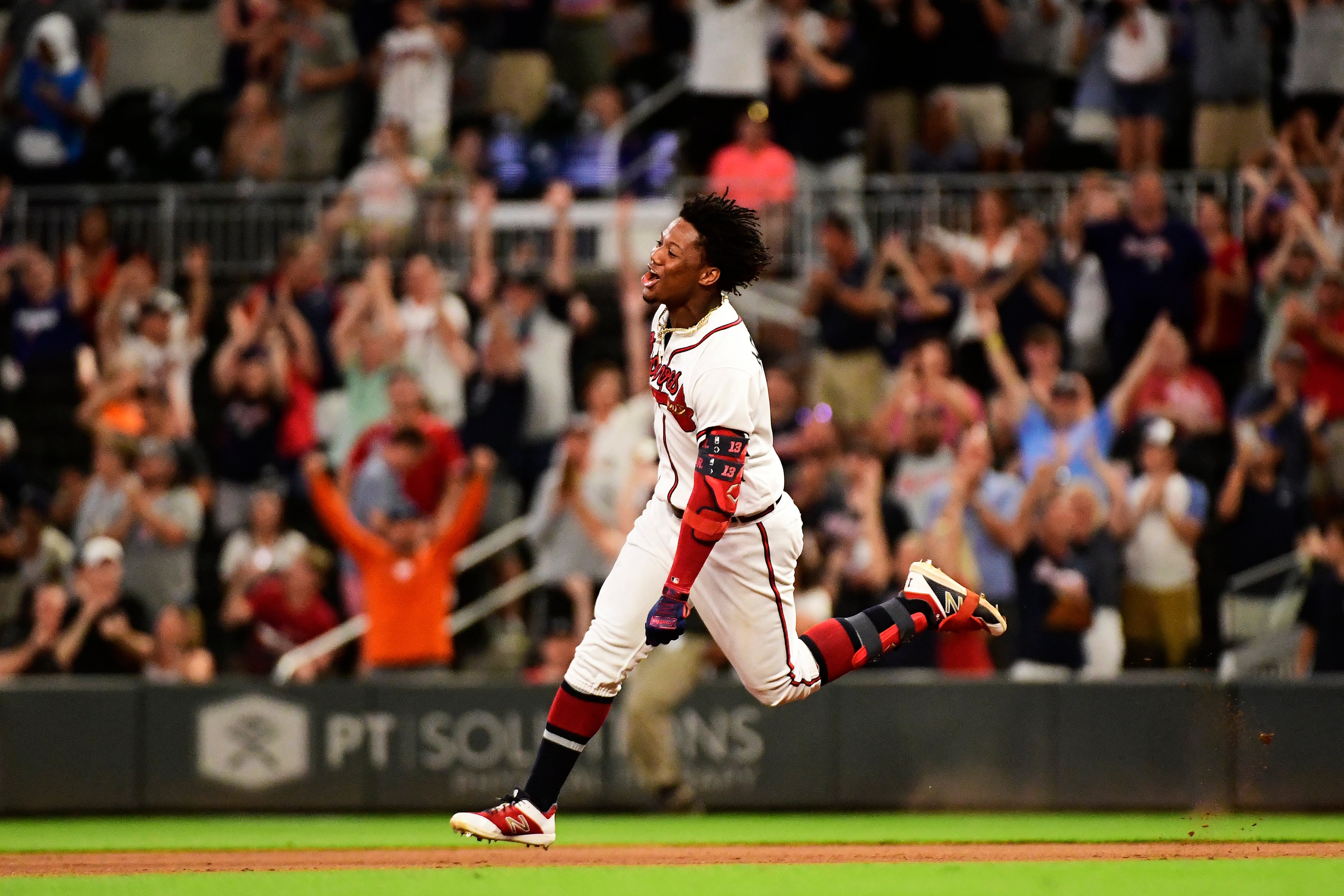 Ronald Acuna Jr. #13 of the Atlanta Braves hits a walk off single in the ninth inning against the Miami Marlins at SunTrust Park on August 22, 2019 in Atlanta, Georgia. (Photo by Logan Riely/Getty Images)
