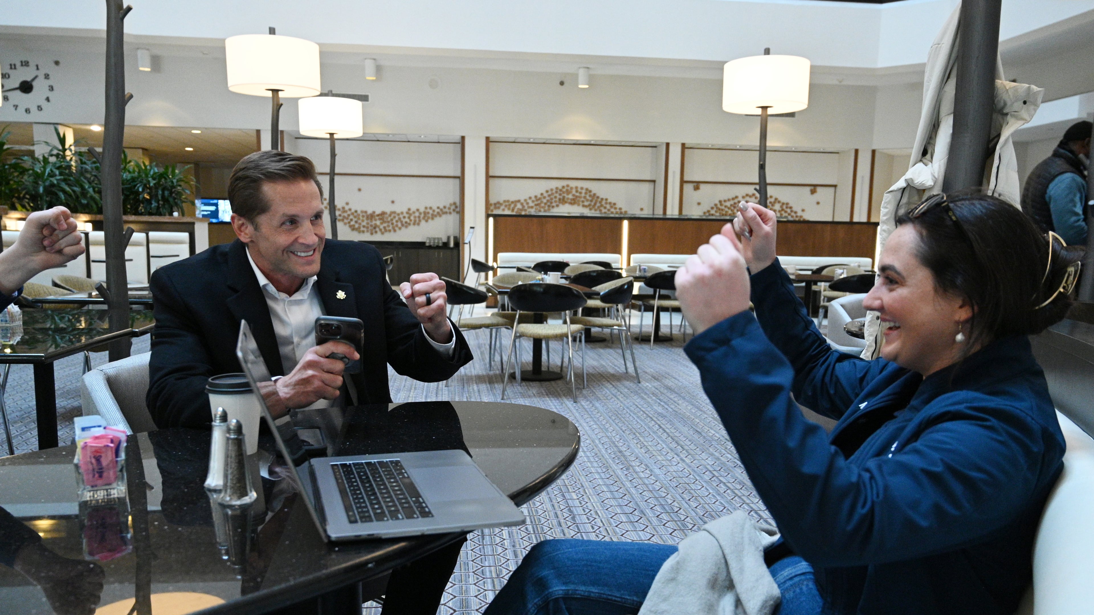 U.S. Rep. Rich McCormick reacts with Brittany McGivern (right) after he successfully made a call to encourage to vote for presidential candidate Florida Gov. Ron DeSantis at a hotel lobby, Sunday, January 14, 2024, in West Des Moines, Iowa. (Hyosub Shin / Hyosub.Shin@ajc.com)