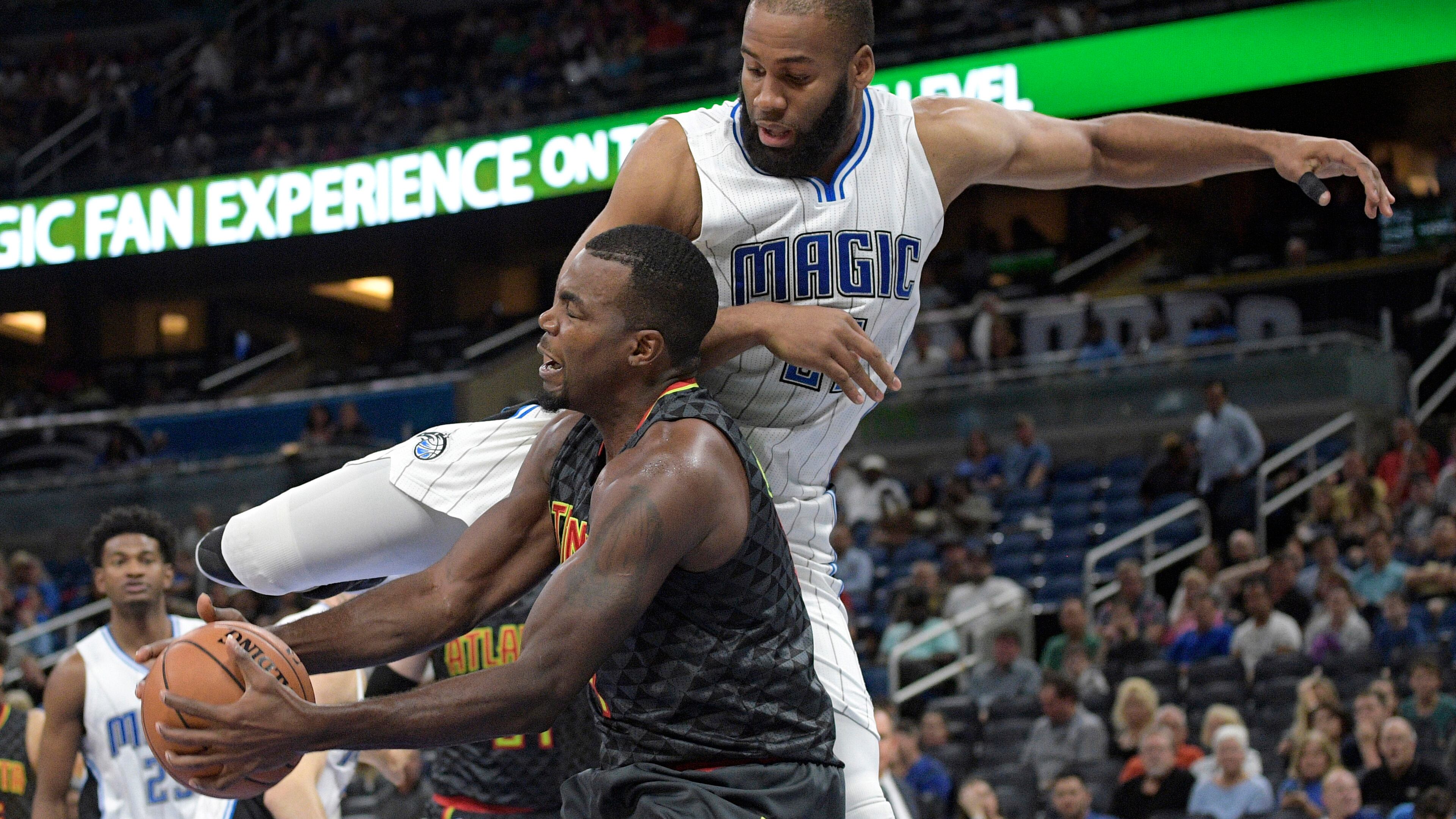 Hawks forward Paul Millsap, front, is fouled by Magic center Arinze Onuaku while going up to shoot during the first half of an NBA preseason basketball game in Orlando, Fla., Sunday, Oct. 16, 2016. (AP Photo/Phelan M. Ebenhack)