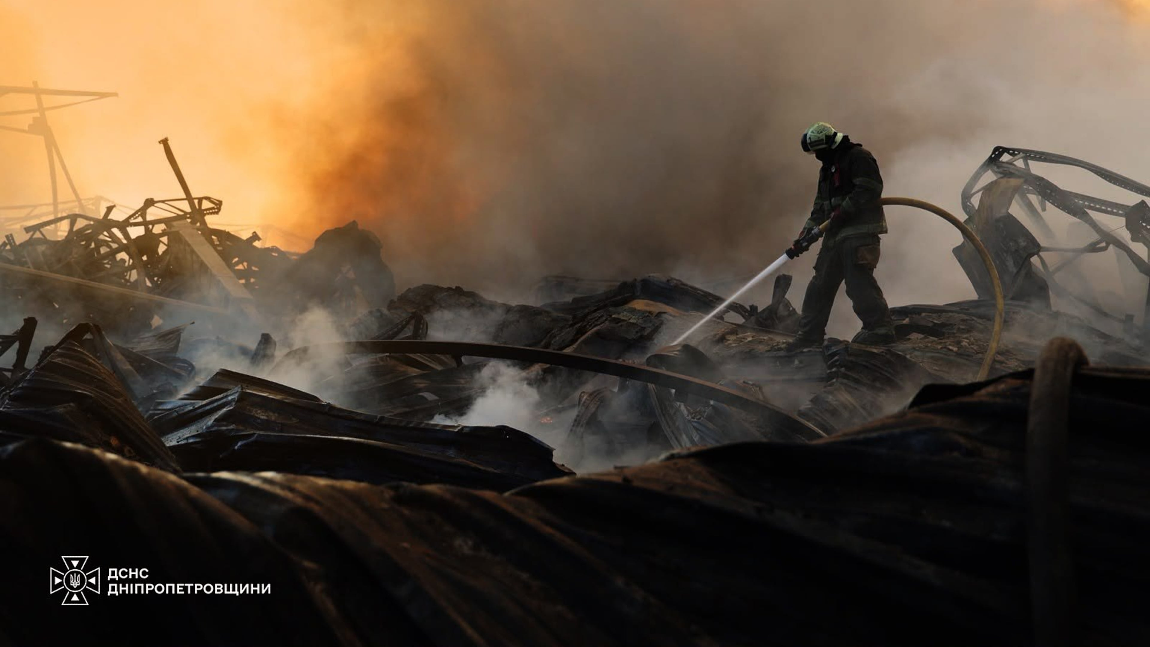 In this photo provided by the Ukrainian Emergency Service, a firefighter puts out a fire following a Russian missile attack in Dnipropetrovsk region, Ukraine, Tuesday, Aug. 4, 2026. (Ukrainian Emergency Service via AP)