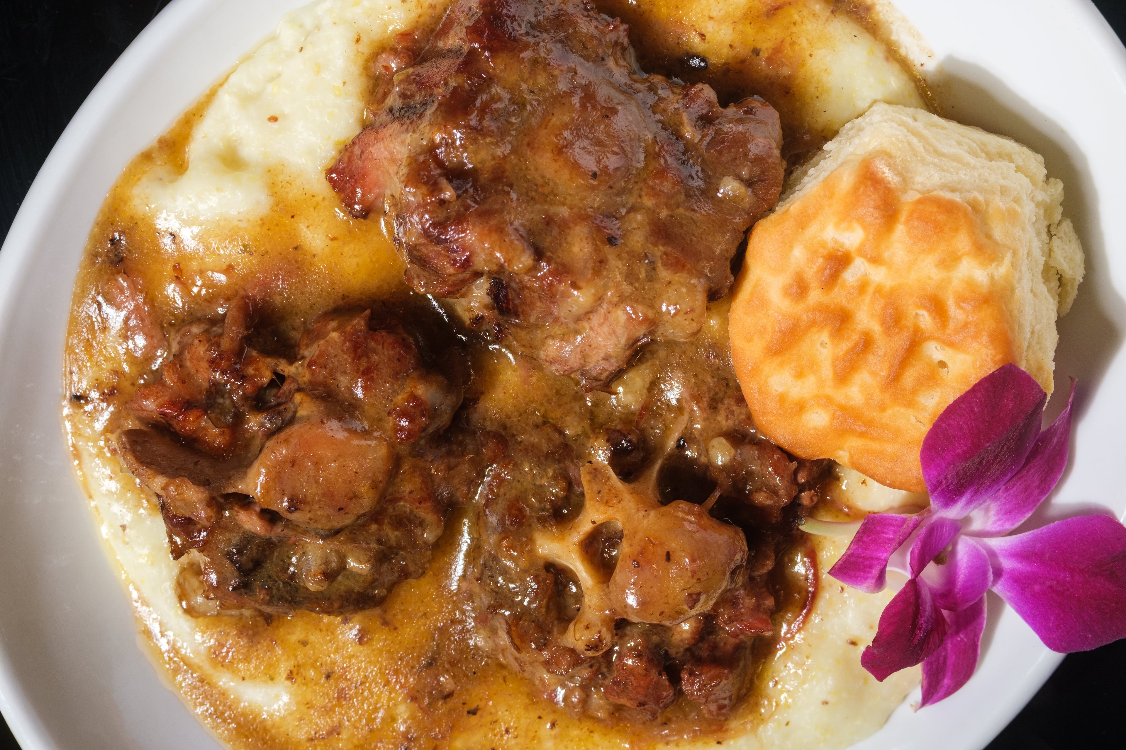 At T's Brunch Bar, find one of its most popular menu items, oxtail and grits. (Courtesy of T's Brunch Bar)