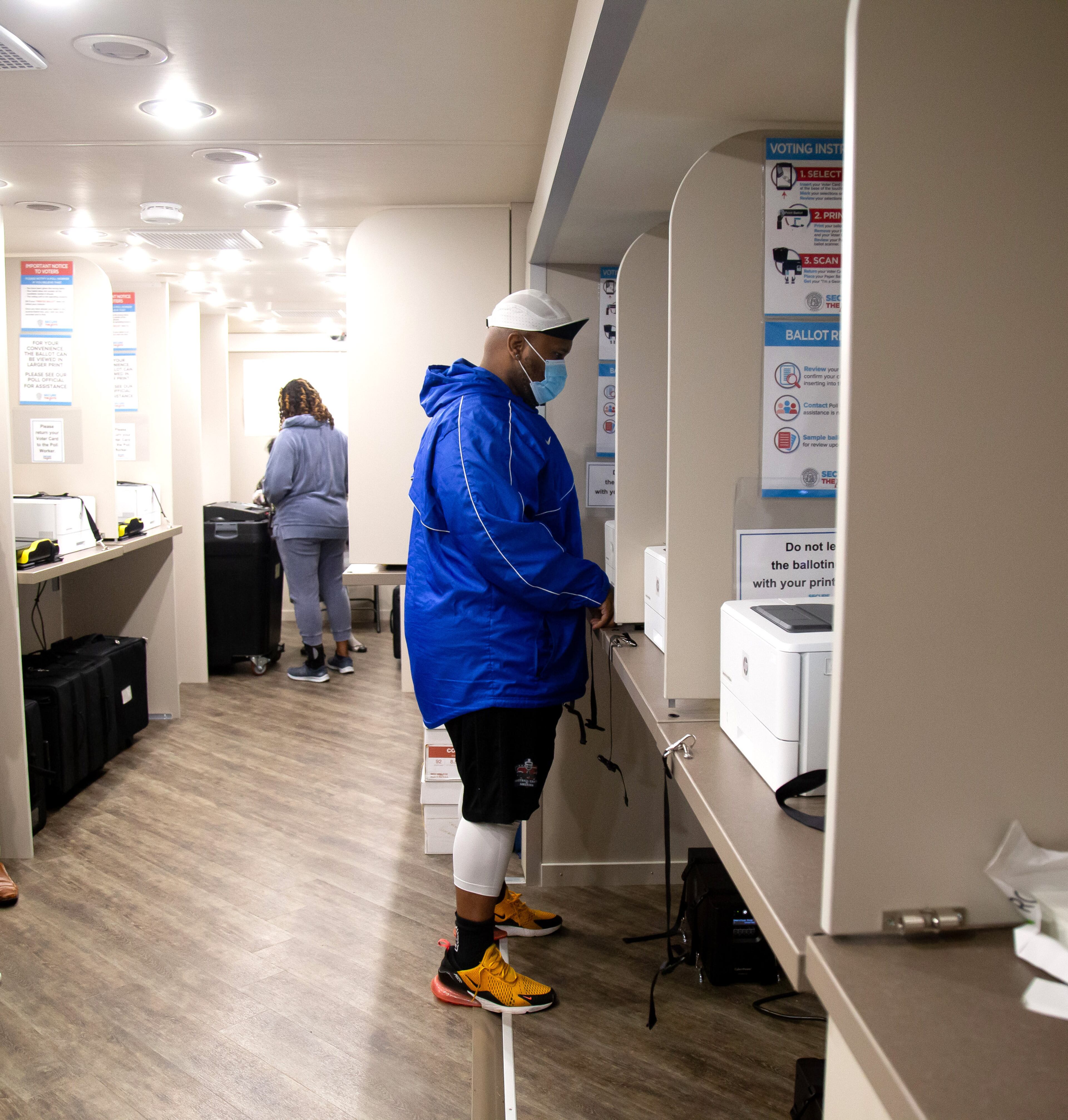 Voters cast their vote from a Motor Voter Bus after the Wolf Creek Library lost power as tropical storm Zeta moved through the area Thursday. STEVE SCHAEFER / SPECIAL TO THE AJC