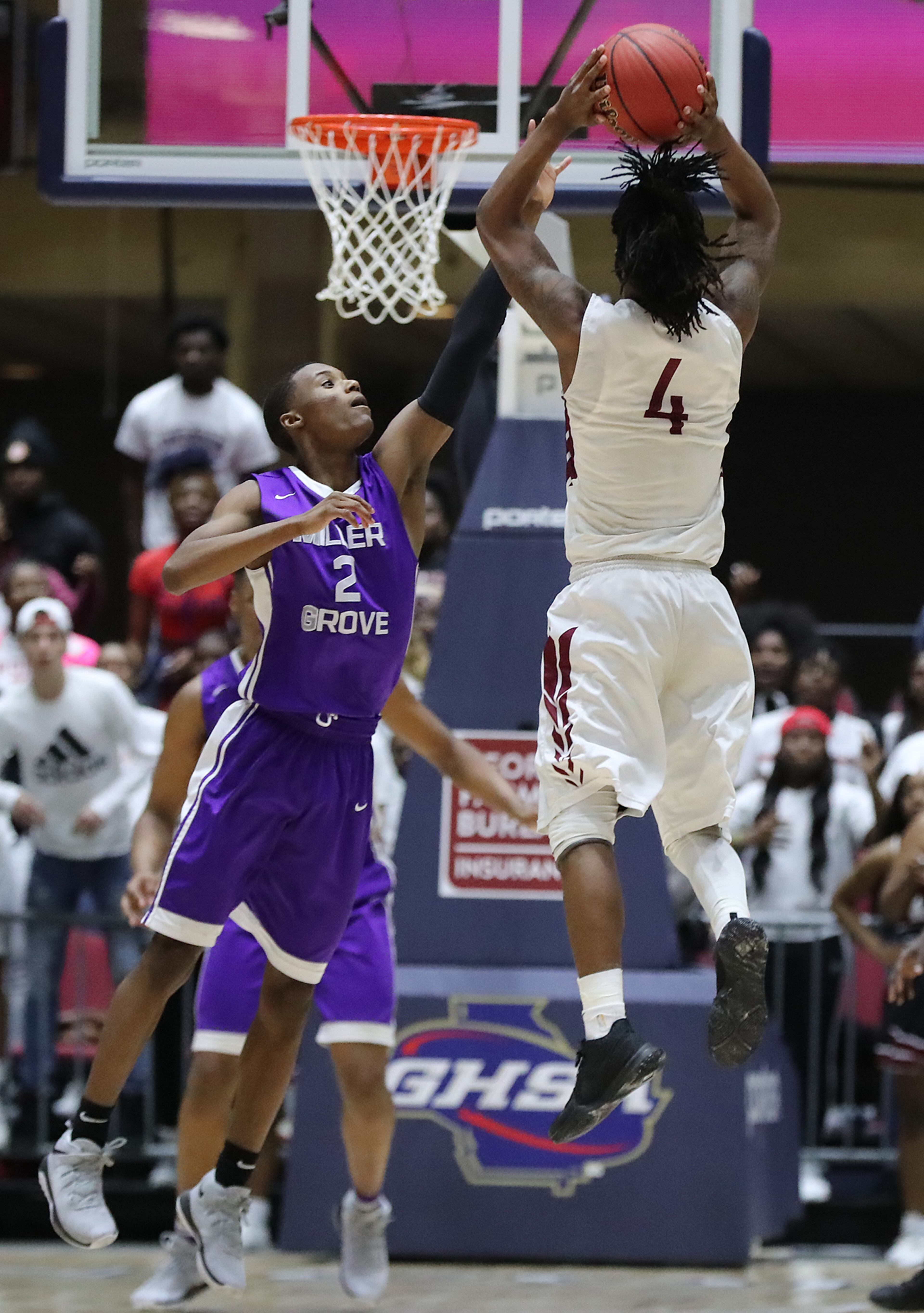 March 8, 2018 Macon: Warner Robins guard Jacolbey Owens hits a three point shot over Miller Grove guard Timothy Stargell Jr. for a 67-64 victory in the final seconds of their GHSA state basketball championship game on Thursday, March 8, 2018, in Macon. Curtis Compton/ccompton@ajc.com
