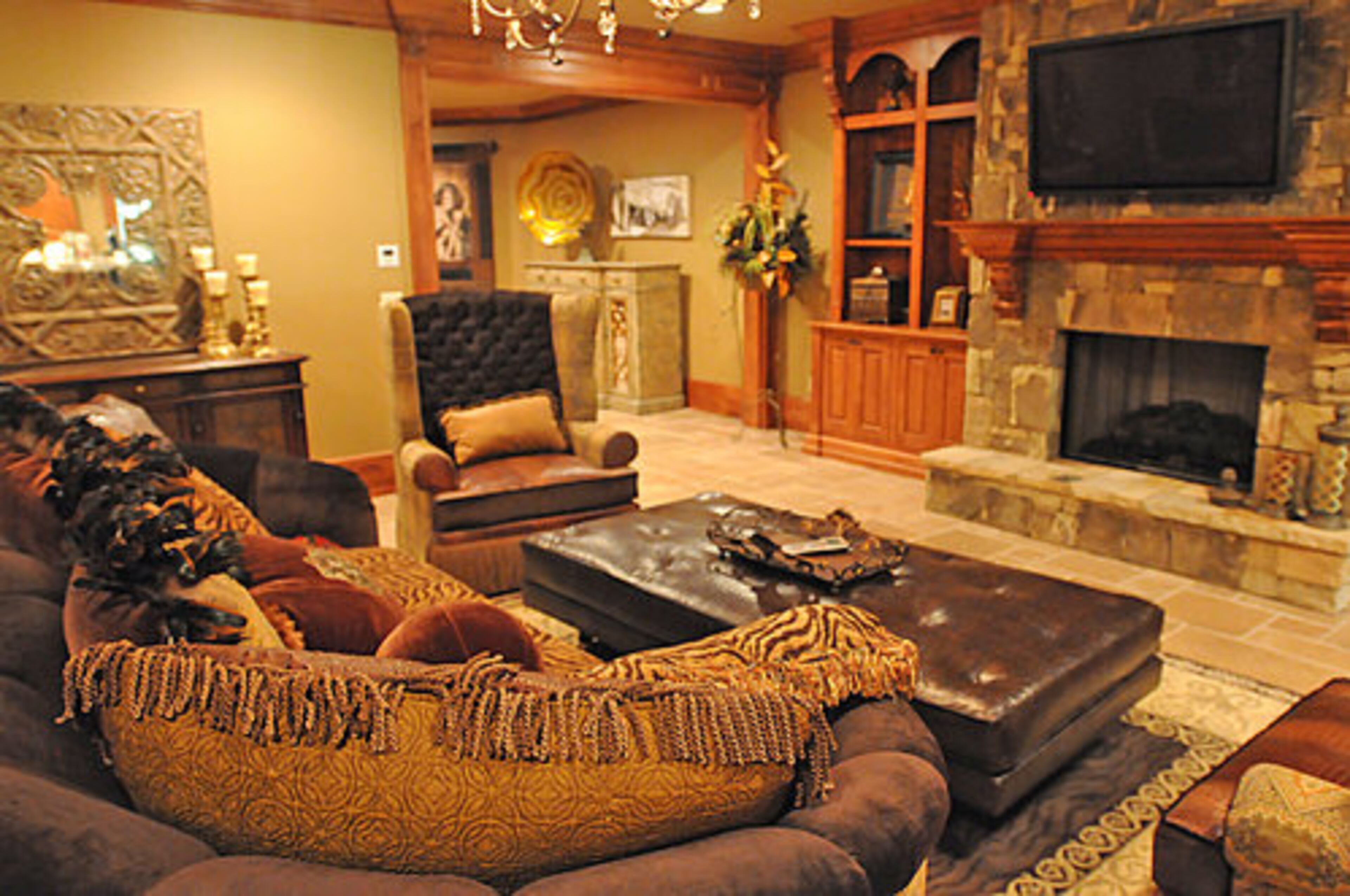 The stone fireplace and hearth are a focal point of the terrace-level family room.