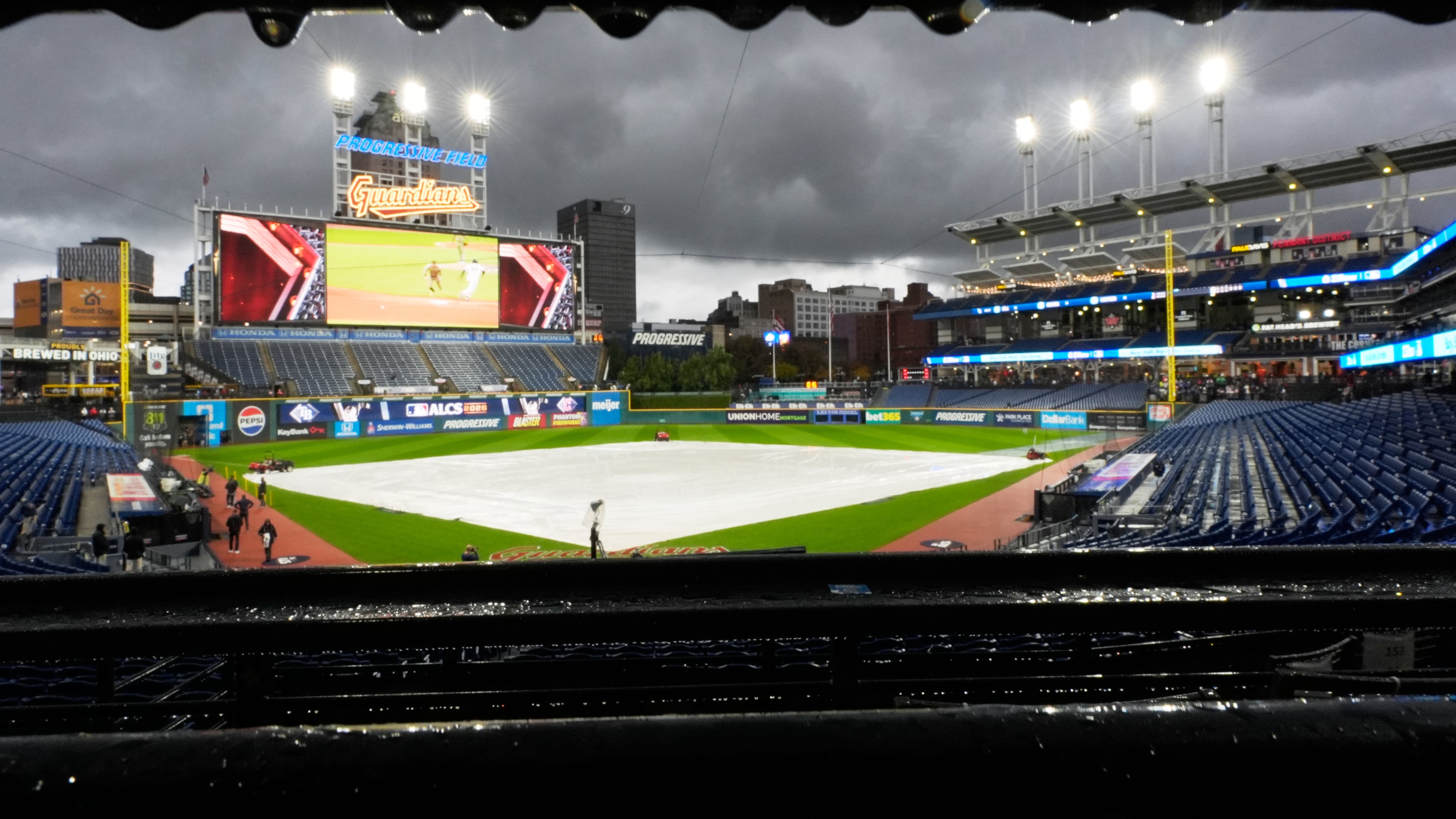 The field is covered before Game 4 of an American League Championship Series baseball game between the Cleveland Guardians and the Tampa Bay Rays in Cleveland, Friday, Oct. 16, 2026. (AP Photo/David J. Phillip)