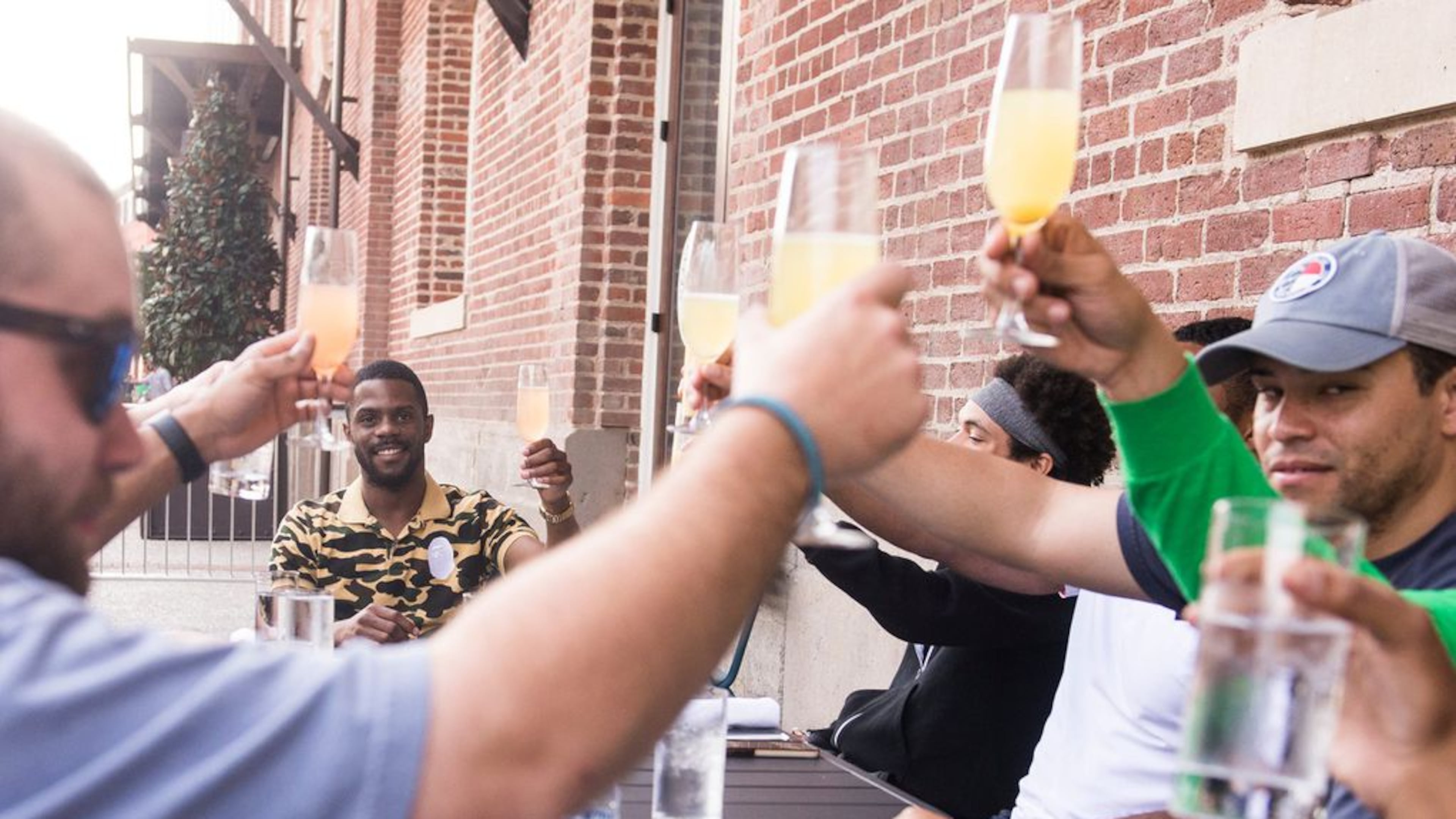 Averitt Scott and his bachelor's party raise a glass outside of Plant Riverside on Saturday. The group chose Savannah to celebrate Scott's upcoming nuptials.
