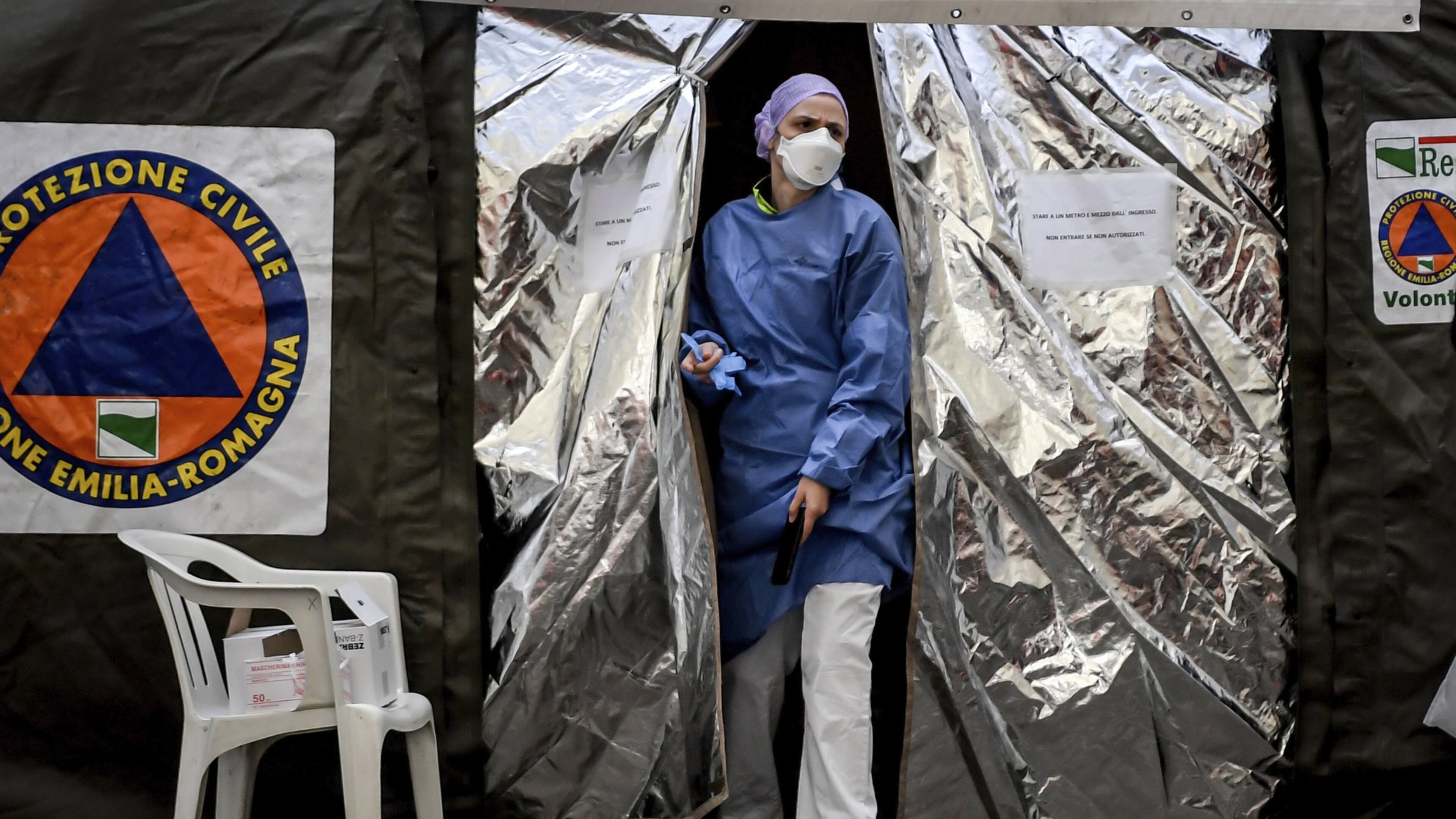 A paramedic at a tent set up by the Italian Civil Protection agency outside the emergency ward of a hospital in Northern Italy on Feb. 27, 2020. Italy has taken strong measures to try and contain the coronavirus’ spread. (Claudio Furlan/Lapresse via AP)