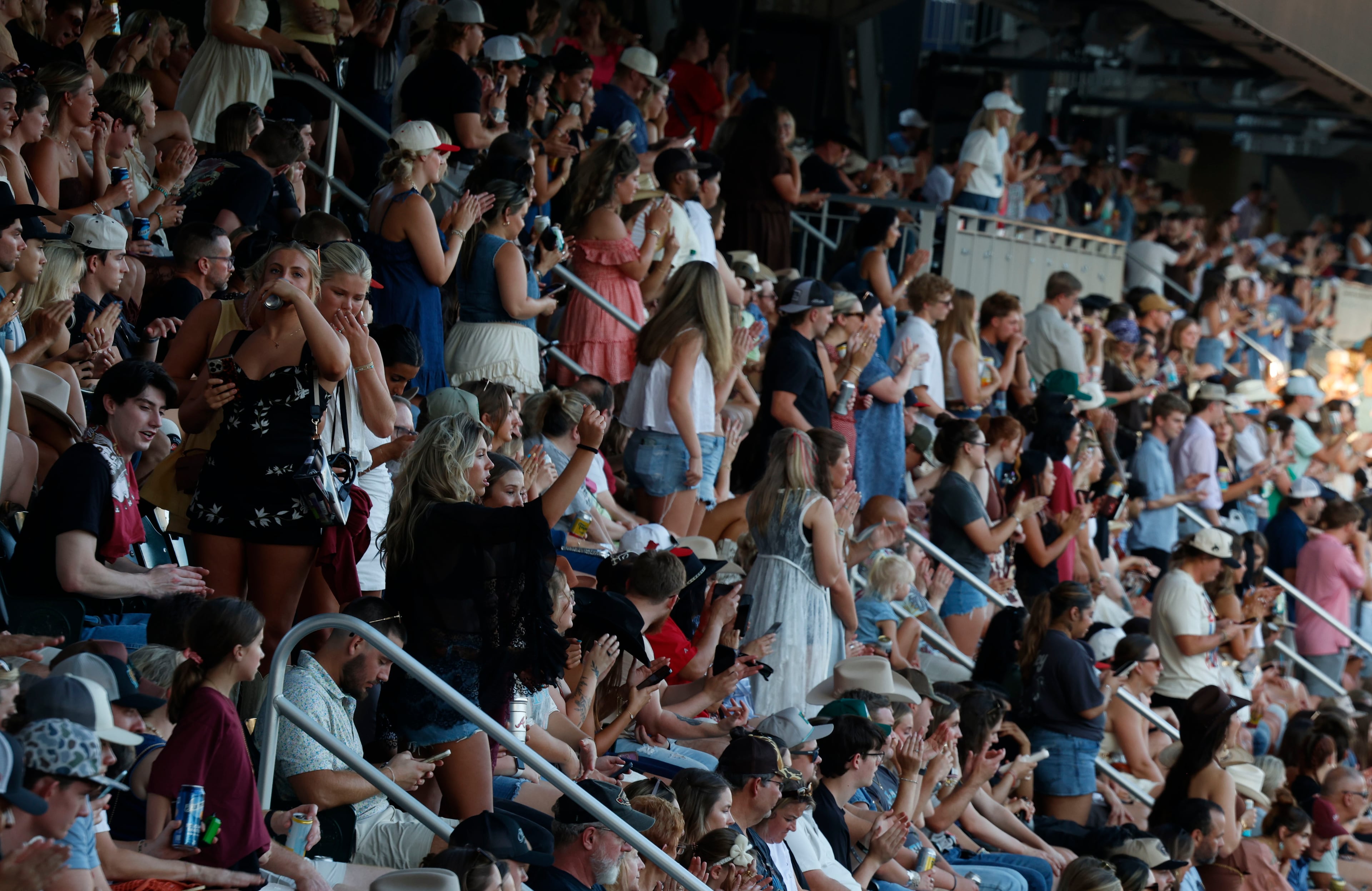 June 13, 2026 - Atlanta, GA: Fans dance and cheer to the music at the Braves Country Fest, an inaugural, a first of its kind celebration of Braves baseball and country music, headlined by Cody Johnson, Ella Langley, ERNEST, and Mackenzie Carpenter inside Truist Park Saturday. (Akili-Casundria Ramsess/For the AJC)