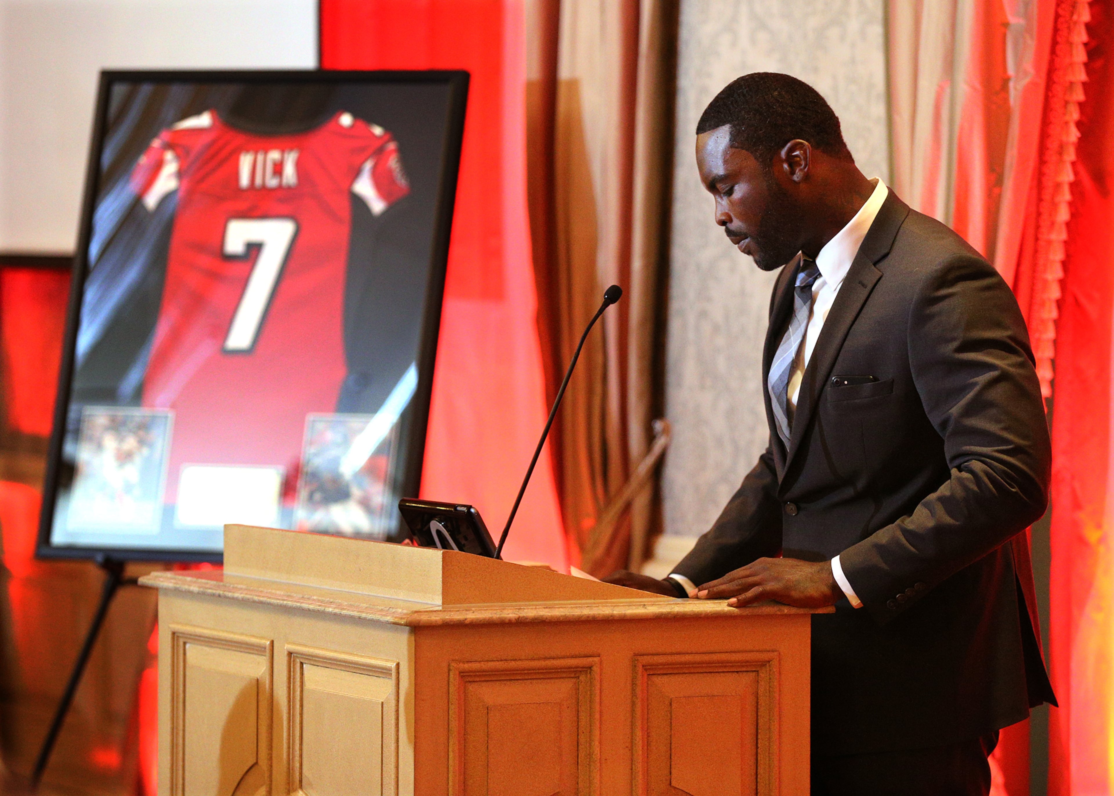 Former Falcons quarterback Michael Vick pauses during his speech while being honored by the Falcons as he officially retires from the NFL on Monday, June 12, 2017, in Atlanta.