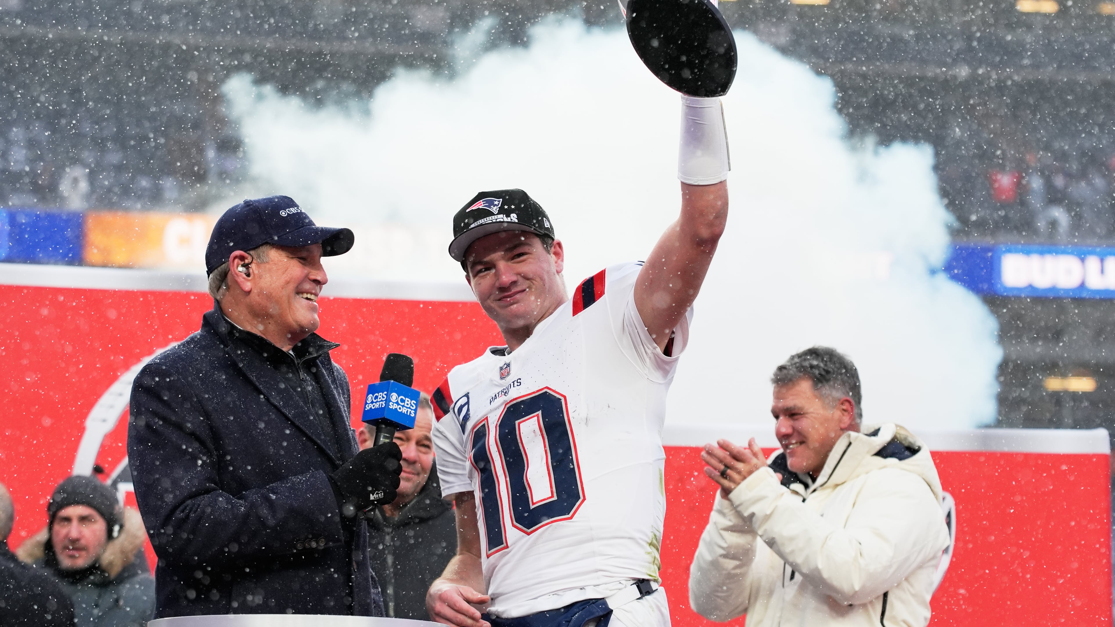 New England Patriots quarterback Drake Maye celebrates with the trophy after the AFC Championship NFL football game between the Denver Broncos and the New England Patriots, Sunday, Jan. 25, 2026, in Denver. (AP Photo/John Locher)
