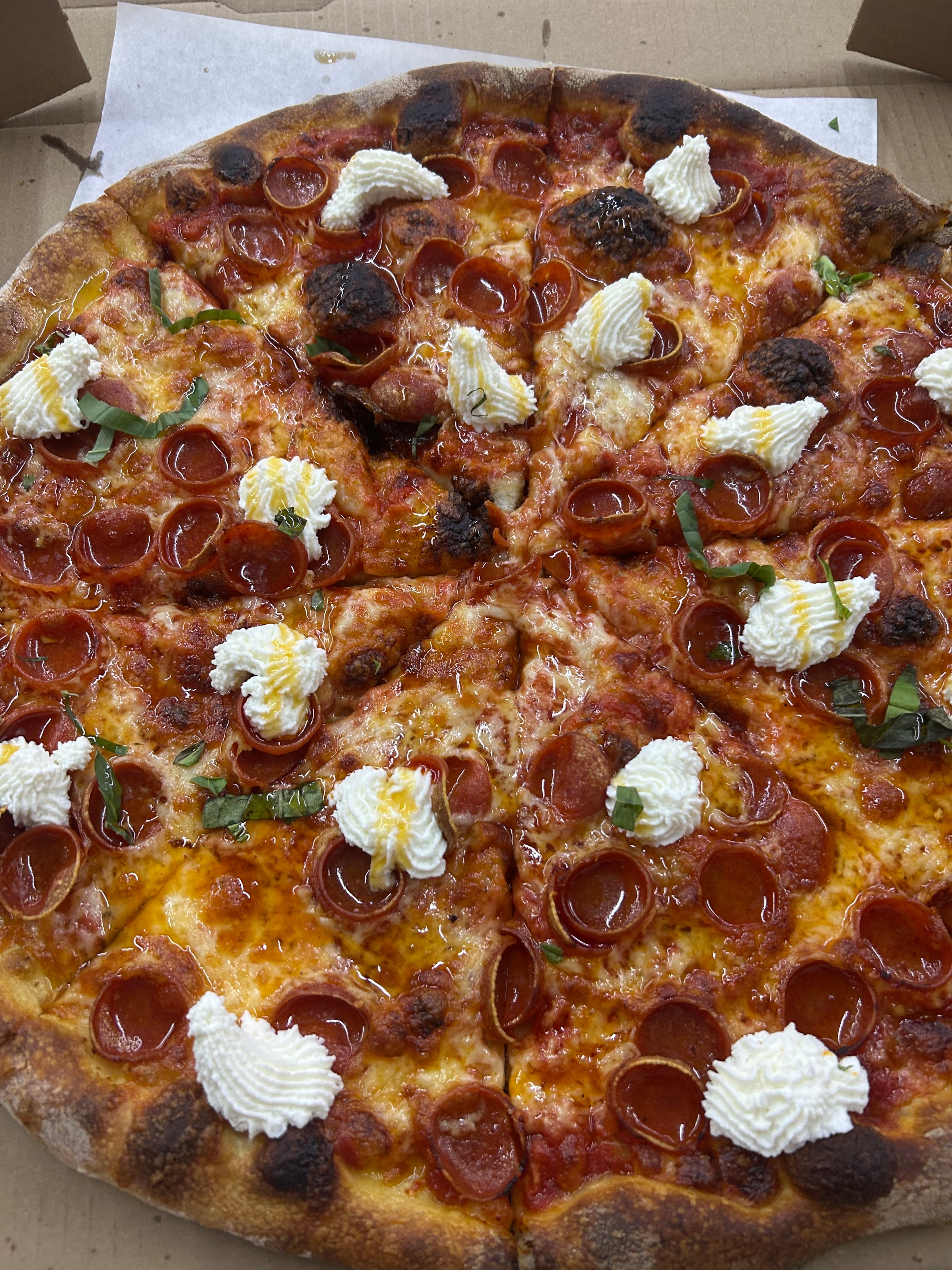 Pizza By Yandys, inside Carniceria Los Pinos in Sandy Springs, serves a hot honey char pepperoni pizza. (Olivia Wakim/AJC)