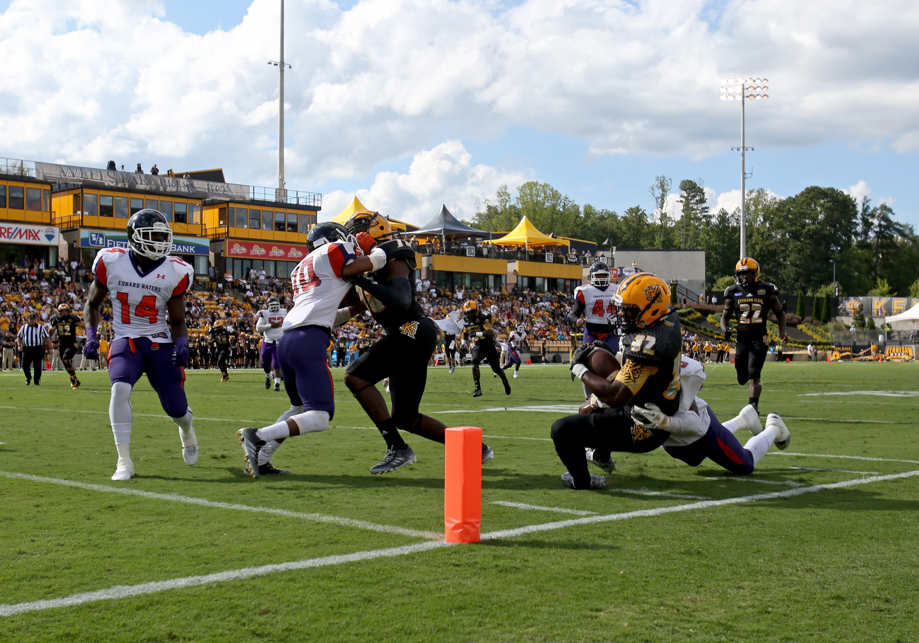 September 12, 2015 - Kennesaw, Ga: Kennesaw State University running back Jae Bowen (32, right) gets stopped short of the end zone by Edward Waters linebacker Joey Williams (9) in the first quarter of their game at Fifth Third Bank Stadium, Saturday, September 12, 2015, in Kennesaw, Ga.. This is the first home game of KSU's inaugural football season. PHOTO / JASON GETZ