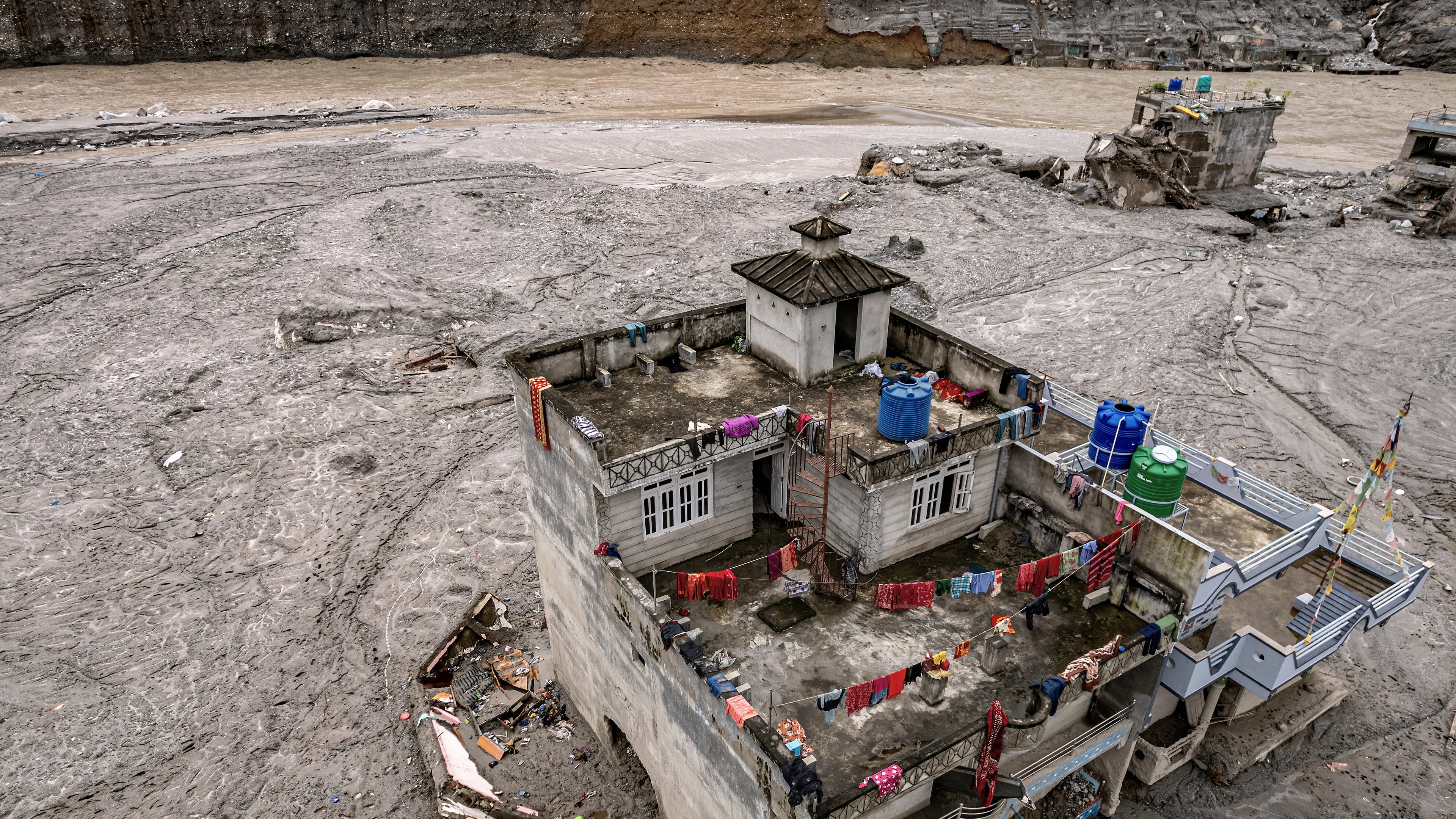 A drone view shows a damaged residential building along the swollen Trishuli River in the aftermath of flash floods in Nepal's Nuwakot district, Thursday, Sept. 3, 2026. (AP Photo/Rajesh Kumar Singh)