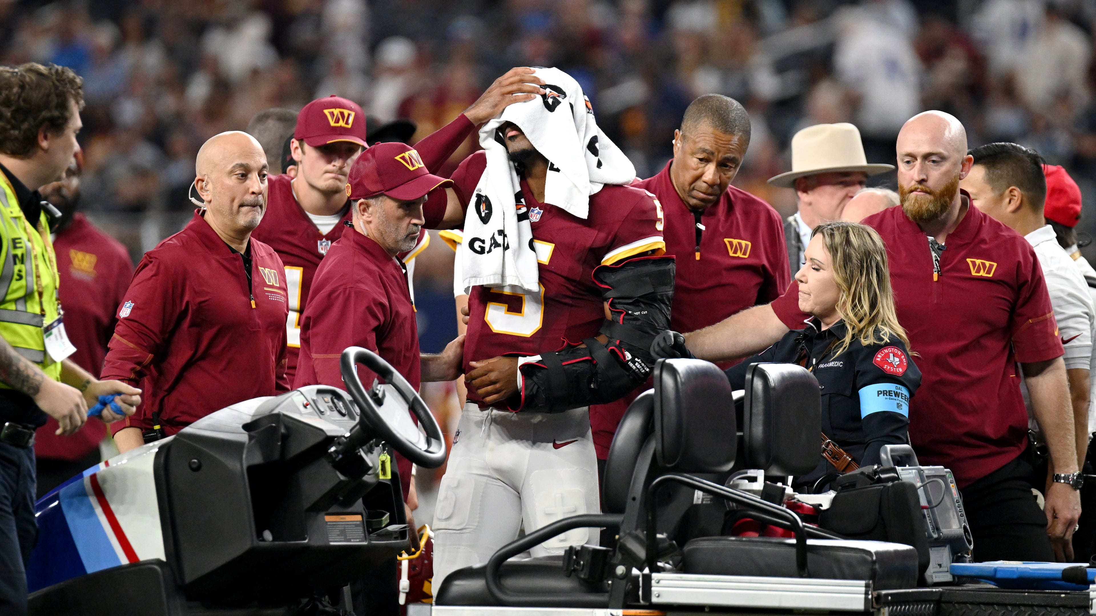 Trainers attend to Washington Commanders quarterback Jayden Daniels (5) after an apparent injury in the first half against the Dallas Cowboys during an NFL football game in Arlington, Texas, Sunday, Sept. 20, 2026. (AP Photo/Jessica Tobias)