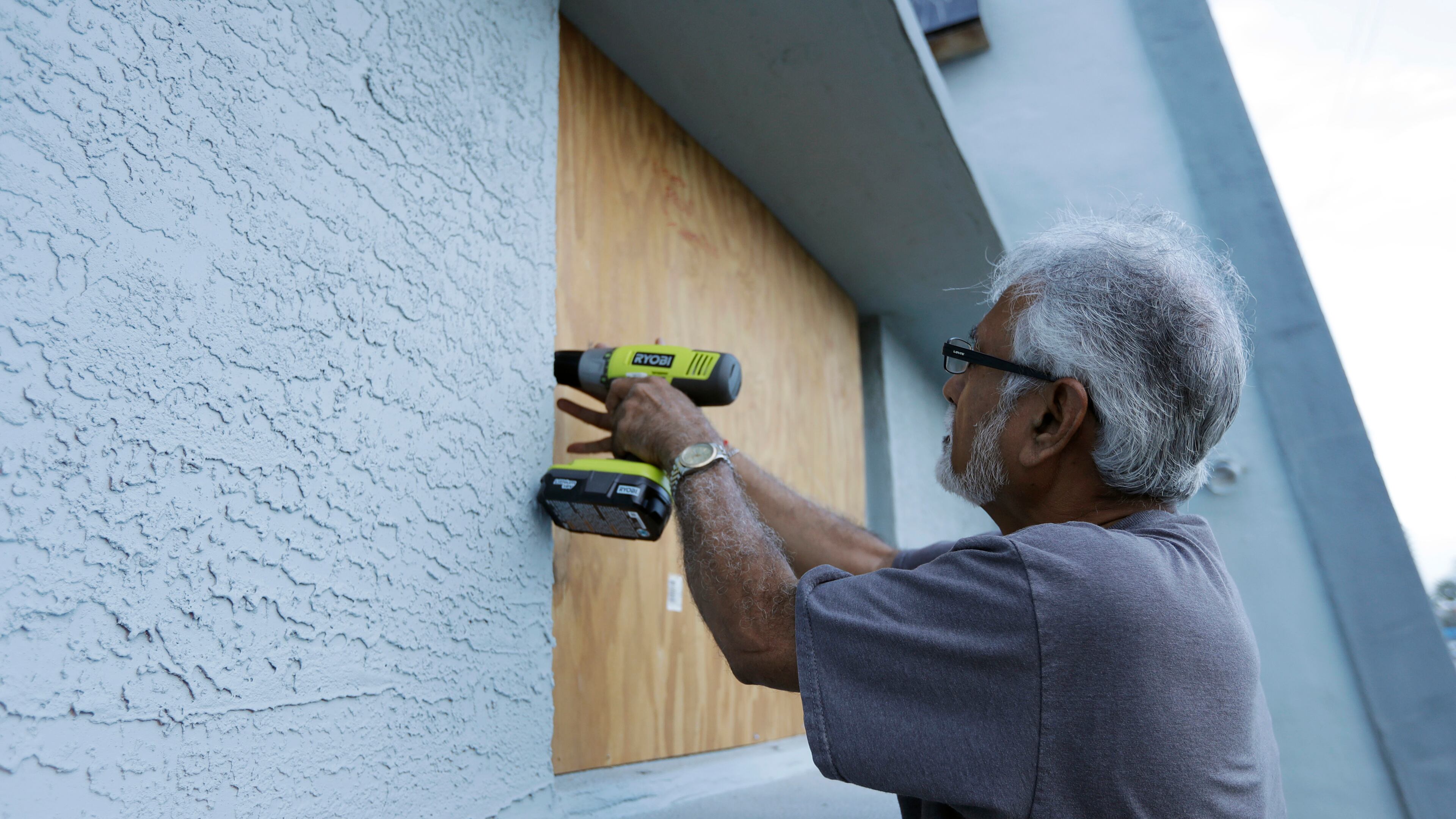 Ray Gohill, owner of the Sahara Motel, does some last minute boarding up of his windows Thursday, Oct. 6, 2016, in Daytona Beach, Fla. Hurrican Matthew continues to make a path for Florida's east coast. (AP Photo/Chris O'Meara)
