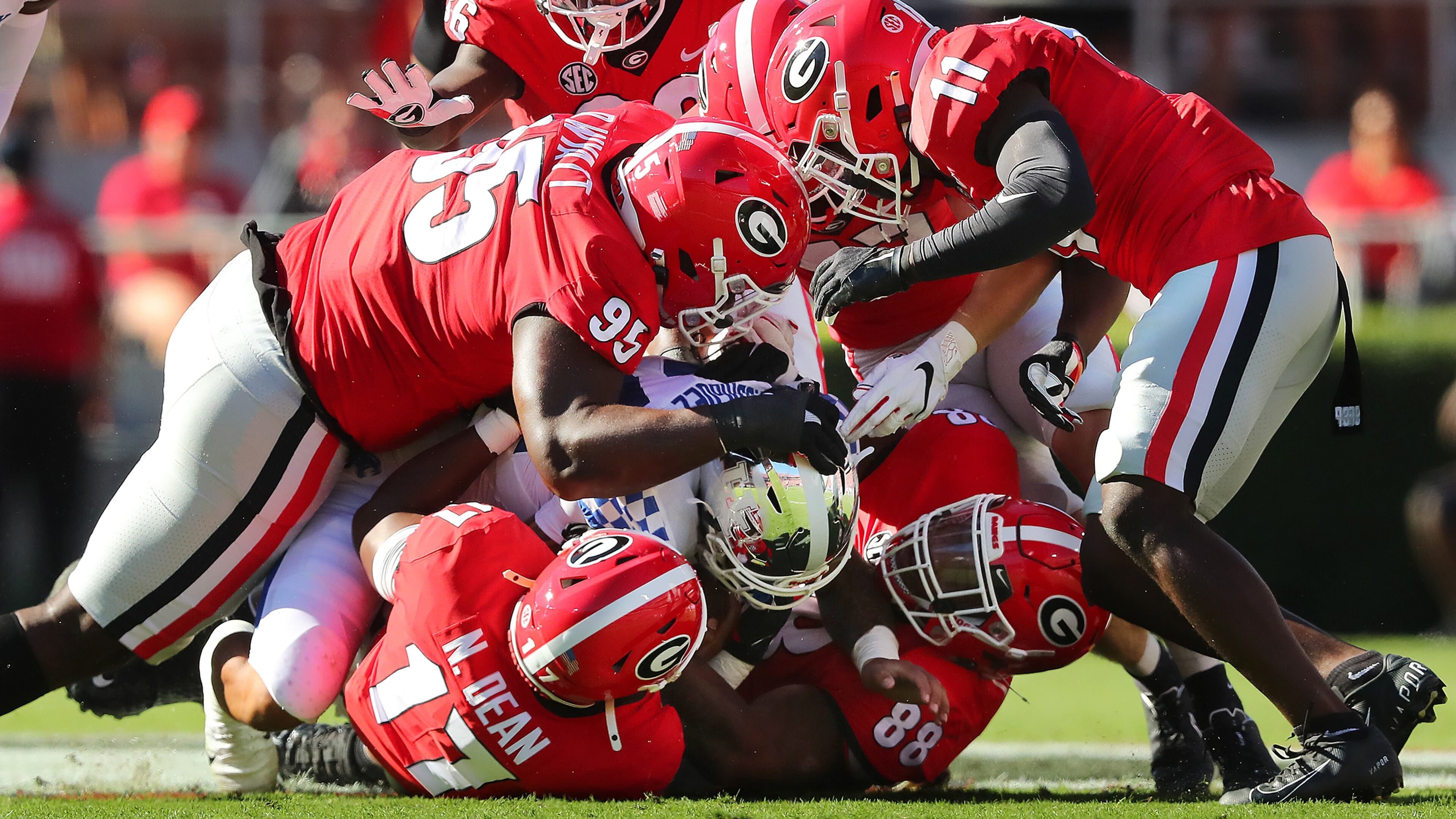 Georgia defenders smother Kentucky running back Chris Rodriguez to bring up third down and 16 yards during the first quarter Saturday, Oct. 16, 2021, at Sanford Stadium in Athens. Georgia won 30-13. (Curtis Compton / Curtis.Compton@ajc.com)