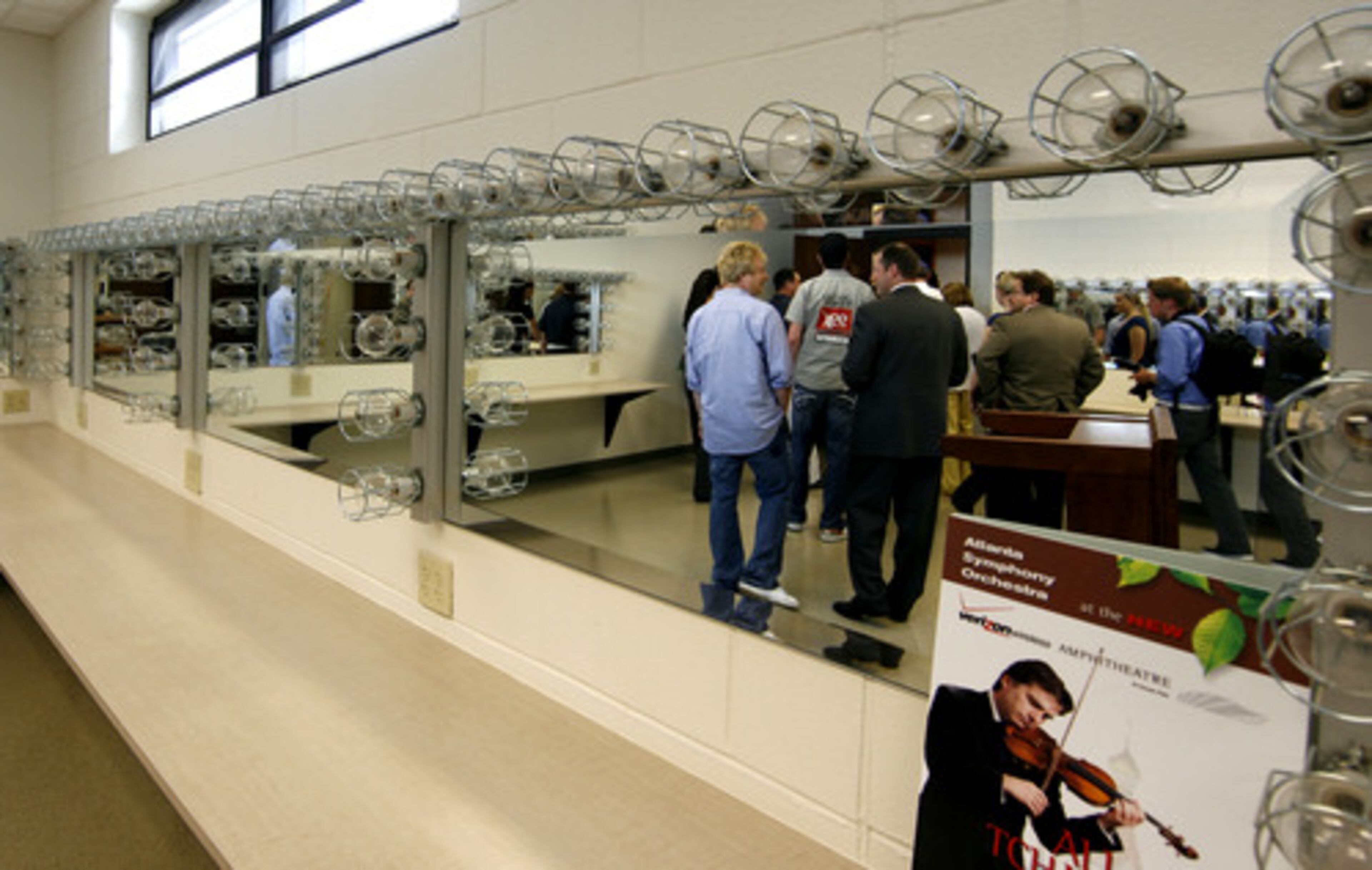 A TOUR GROUP goes backstage to see the dressing rooms.