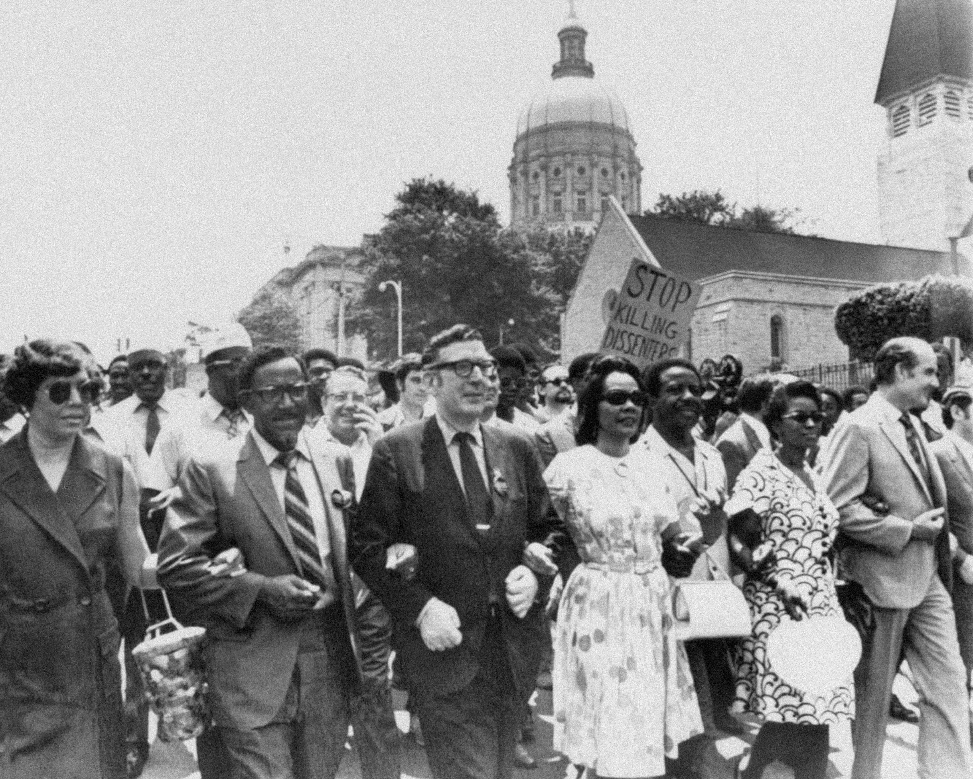 Lowery (second from left) locks arms with others including Coretta Scott King (fourth from left) as they pass the state Capitol in Atlanta in a protest march against war, violence and racial repression in 1970. (AP Photo, File)