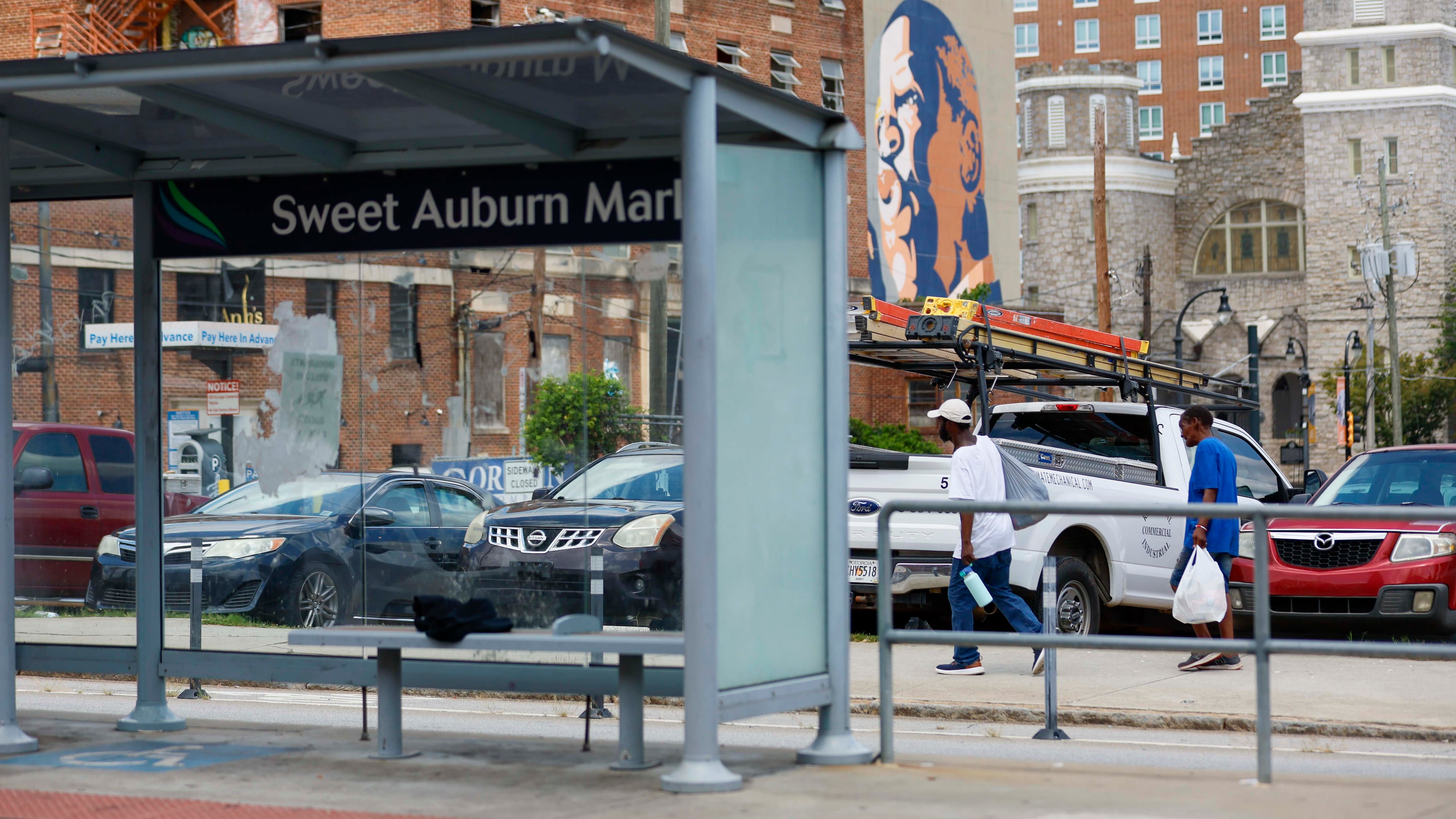 Pedestrians walk along Edgewood Avenue in Atlanta on July 30, 2025, just two days after one person was killed and 10 others were injured in a shooting in the area. A second suspect was recently arrested in the case. (Miguel Martinez/AJC)