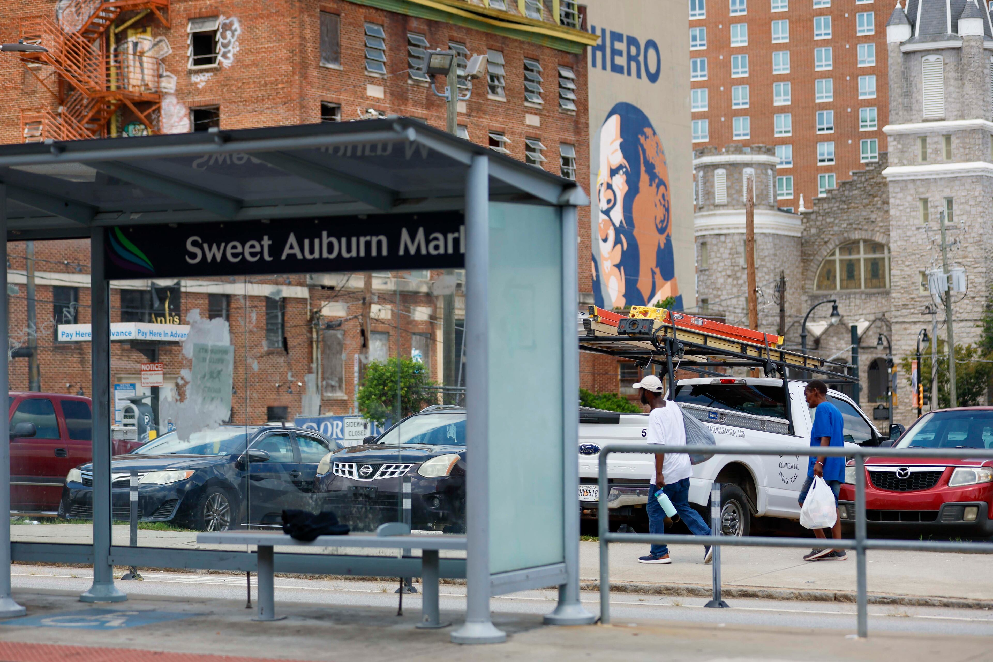 Pedestrians walk along Edgewood Avenue opposite the Municipal Market on Wednesday, July 30, 2025. (Miguel Martinez/AJC)