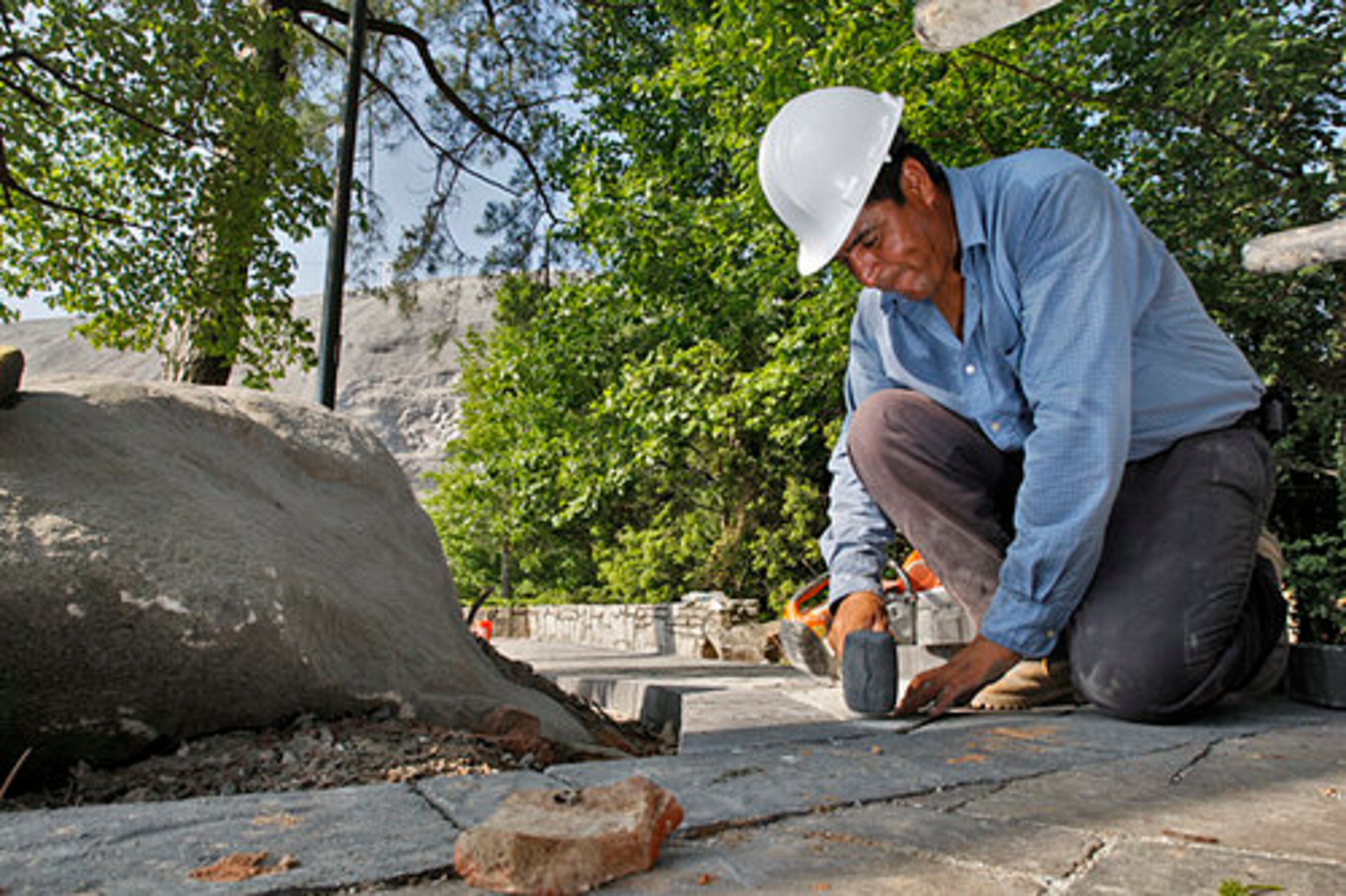 John Rameriz sets pavers down for a walkway.