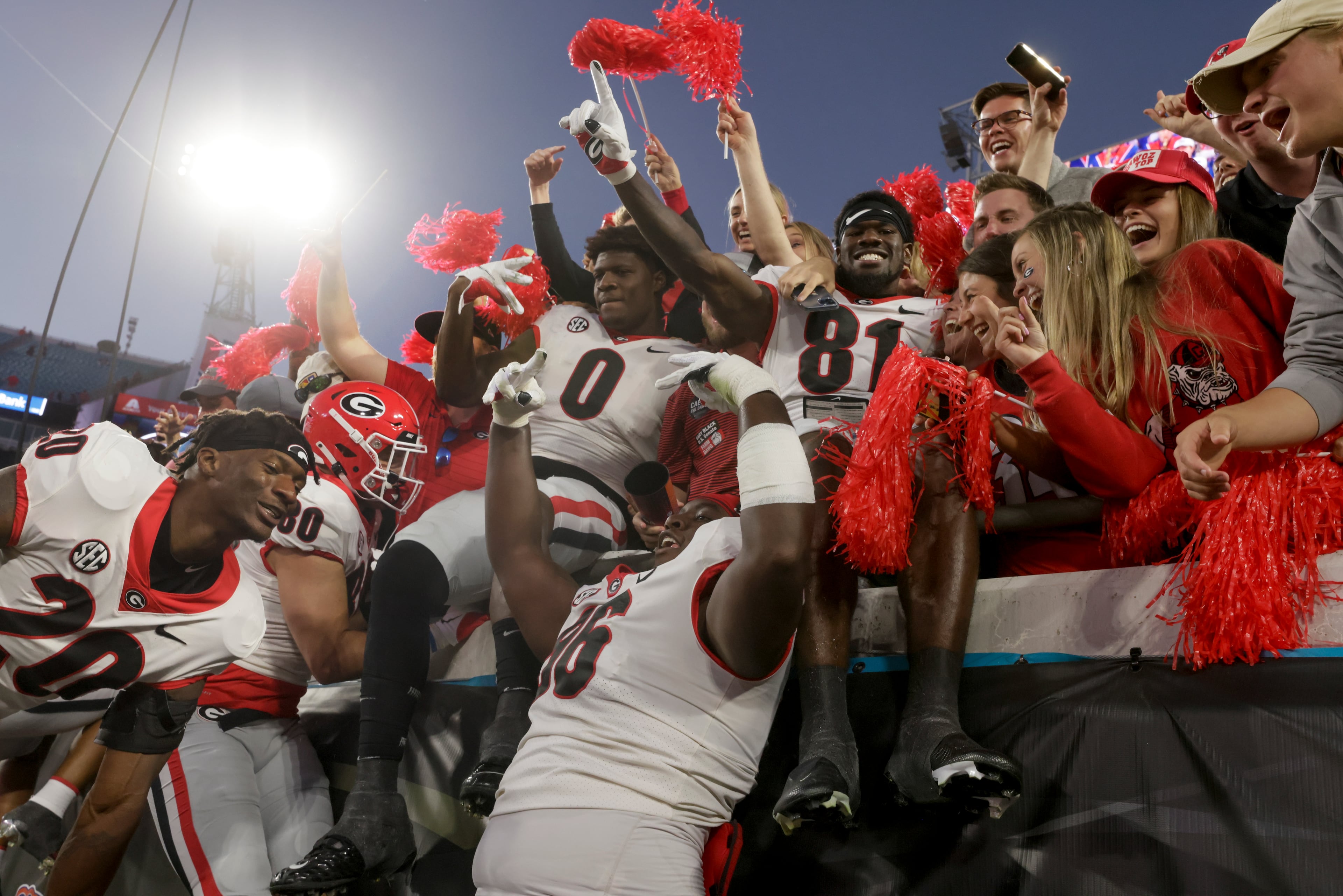 10/30/21 - Jacksonville - Georgia players celebrate with fans after the annual NCCA Georgia vs Florida game at TIAA Bank Field in Jacksonville. Georgia won 34-7. Bob Andres / bandres@ajc.com