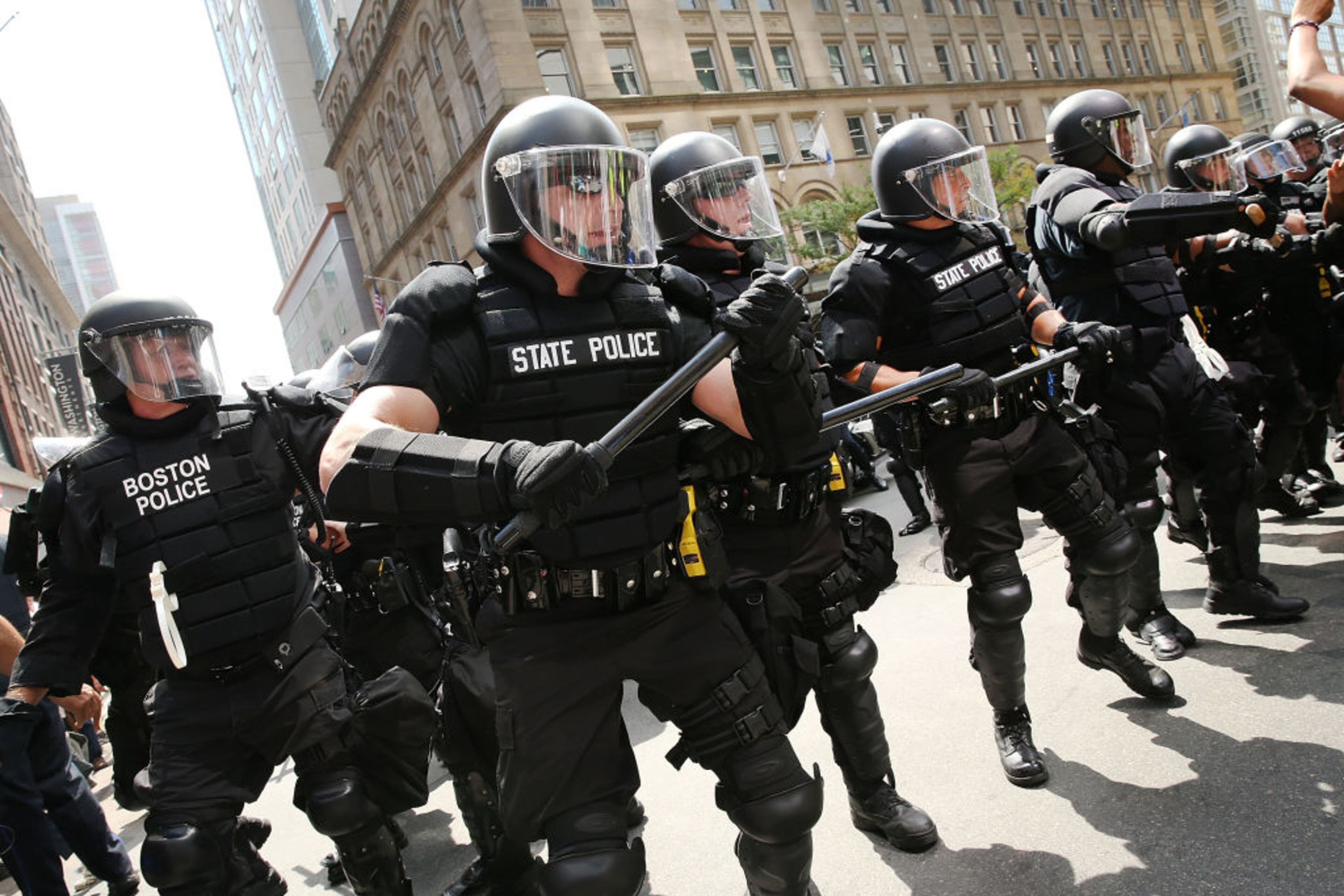 BOSTON, MA - AUGUST 19: Protesters face off with riot police escorting censervative activists following a march in Boston against a planned 'Free Speech Rally' just one week after the violent 'Unite the Right' rally in Virginia left one woman dead and dozens more injured on August 19, 2017 in Boston, United States. Although the rally organizers stress that they are not associated with any alt-right or white supremacist groups, the city of Boston and Police Commissioner William Evans are preparing for possible confrontations at the afternoon rally. (Photo by Spencer Platt/Getty Images)