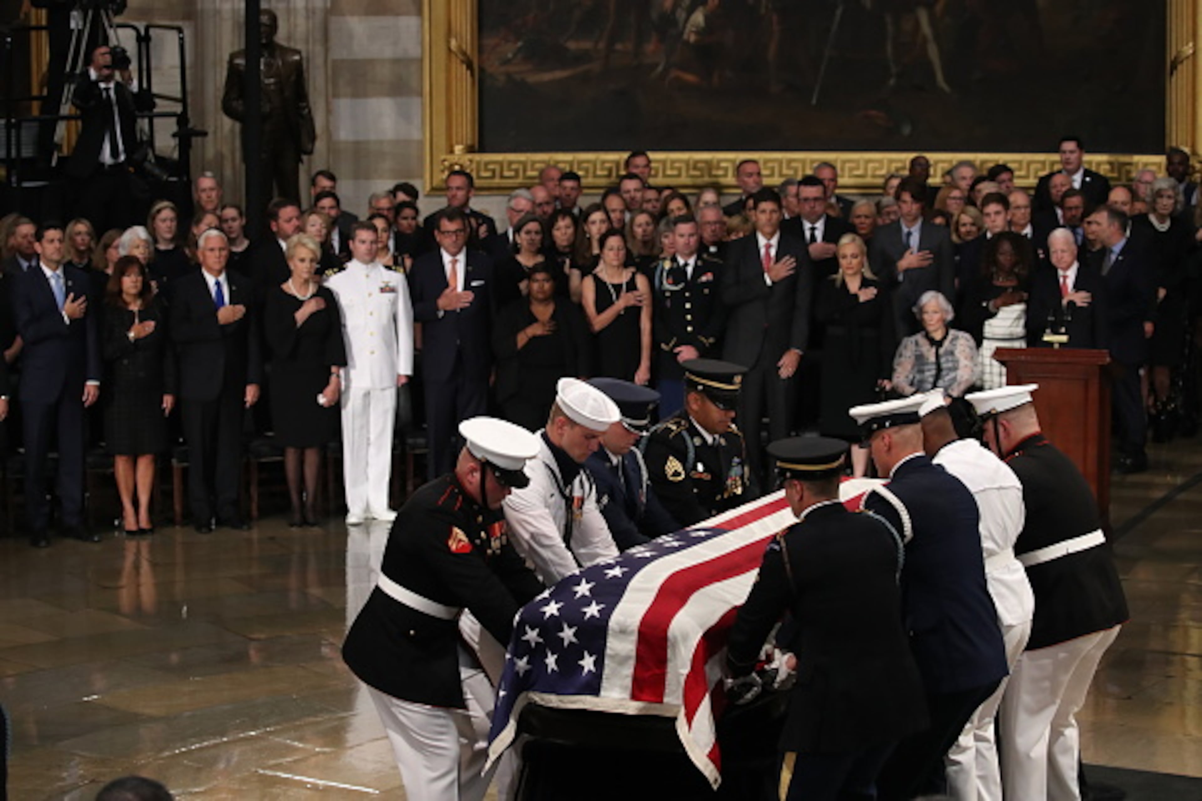 WASHINGTON, DC - AUGUST 31: The flag-draped casket of US Senator John McCain arrives inside the Rotunda of the U.S. Capitol, August 31, 2018 in Washington, DC. A Democrat who voted for Hillary Clinton, Farone said McCain did what was right. "He never took the easy way out, he knew actions speak louder than words and he never tweeted about it. He just got it done," she said. The late senator died August 25 at the age of 81 after a long battle with brain cancer. He will lie in state at the U.S. Capitol Friday, a rare honor bestowed on only 31 people in the past 166 years. Sen. McCain will be buried at his final resting place at the U.S. Naval Academy on Sunday. (Photo by Drew Angerer/Getty Images)