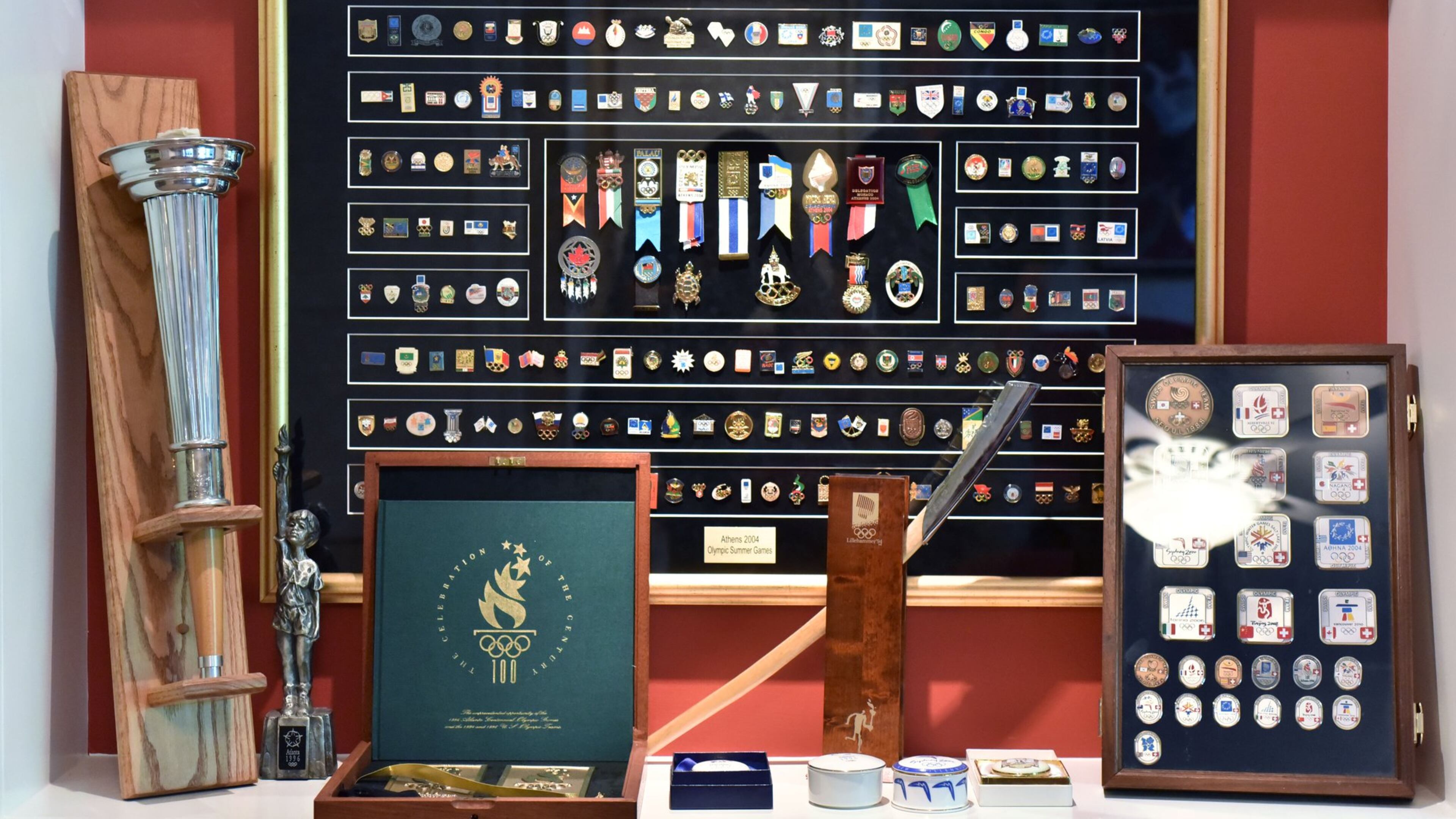 Scott Reed has thousands of Olympic pins, but his best items are displayed in shadow boxes at his home in Lilburn. “Some of them are real works of art,” he says. HYOSUB SHIN / HSHIN@AJC.COM