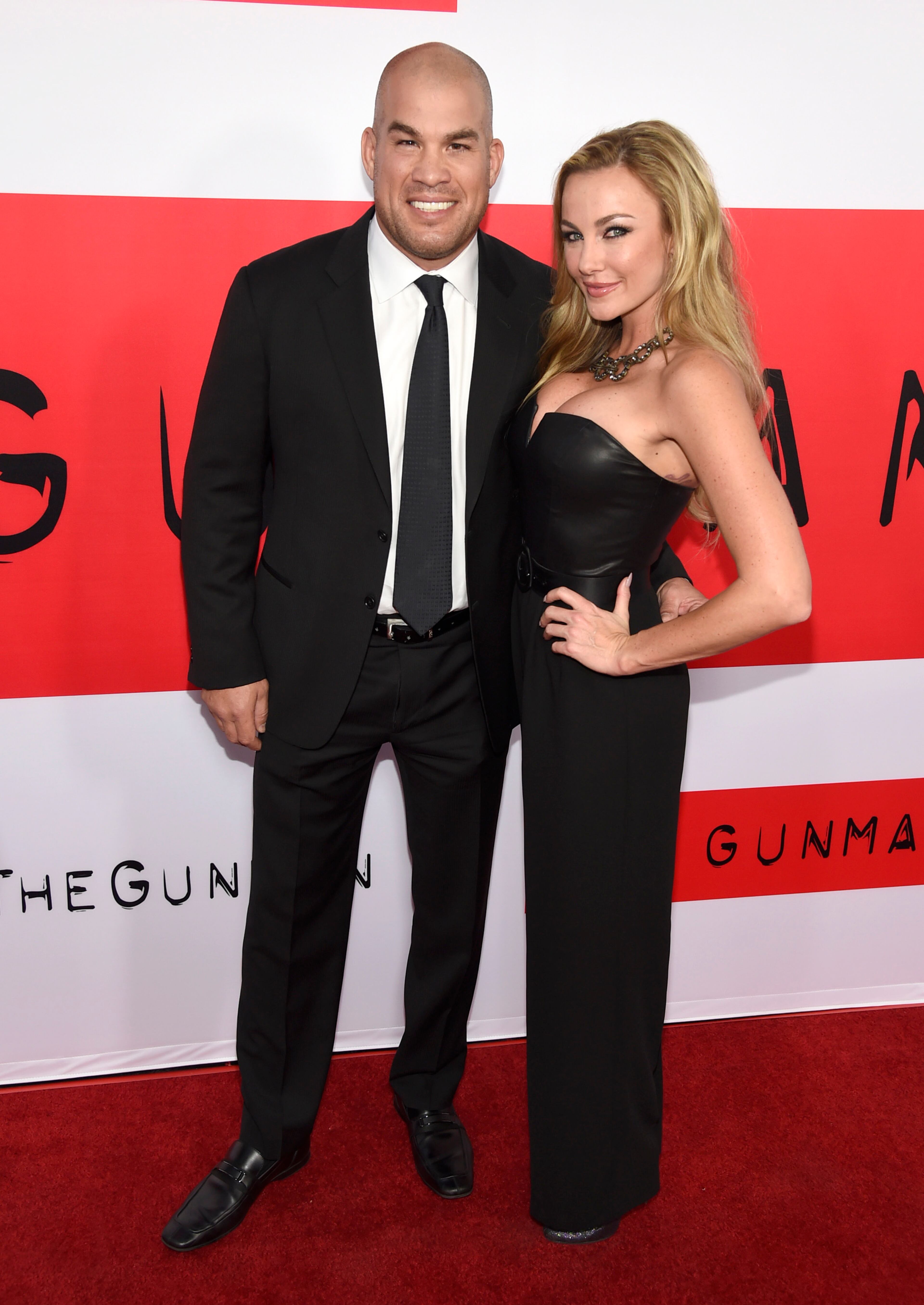 Tito Ortiz, left, and Amber Miller arrive at the Los Angeles premiere of "The Gunman" at Regal Cinemas LA LIVE on Thursday, March 12, 2015. (Photo by Chris Pizzello/Invision/AP)