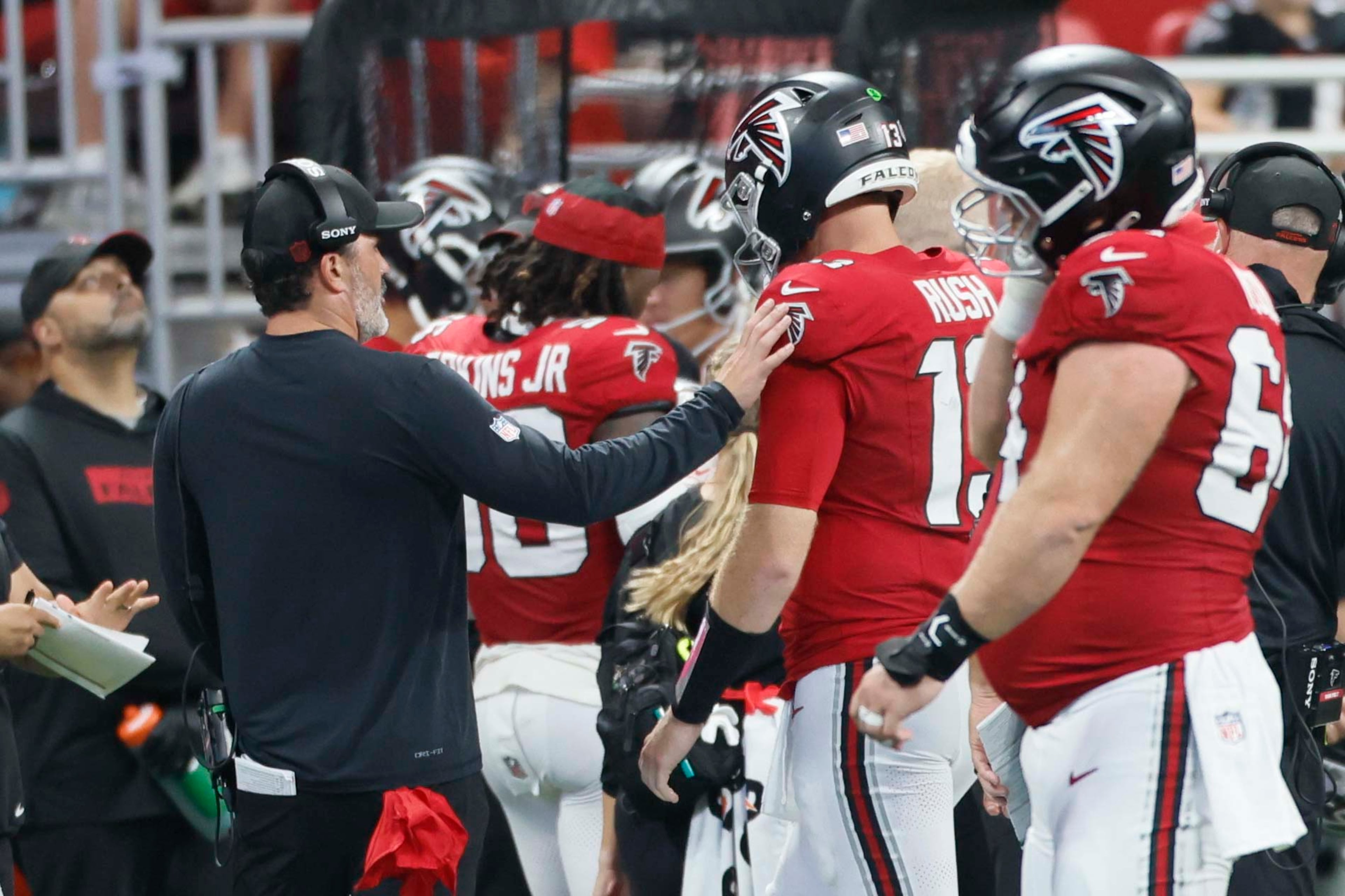 Atlanta Falcons head coach Kevin Stefanski tries to speak with Atlanta Falcons quarterback Cooper Rush (13) after an interception during the second half of an NFL game against the Carolina Panthers at Mercedes-Benz Stadium in Atlanta on Sunday, Sept. 20, 2026. (Miguel Martinez/AJC)