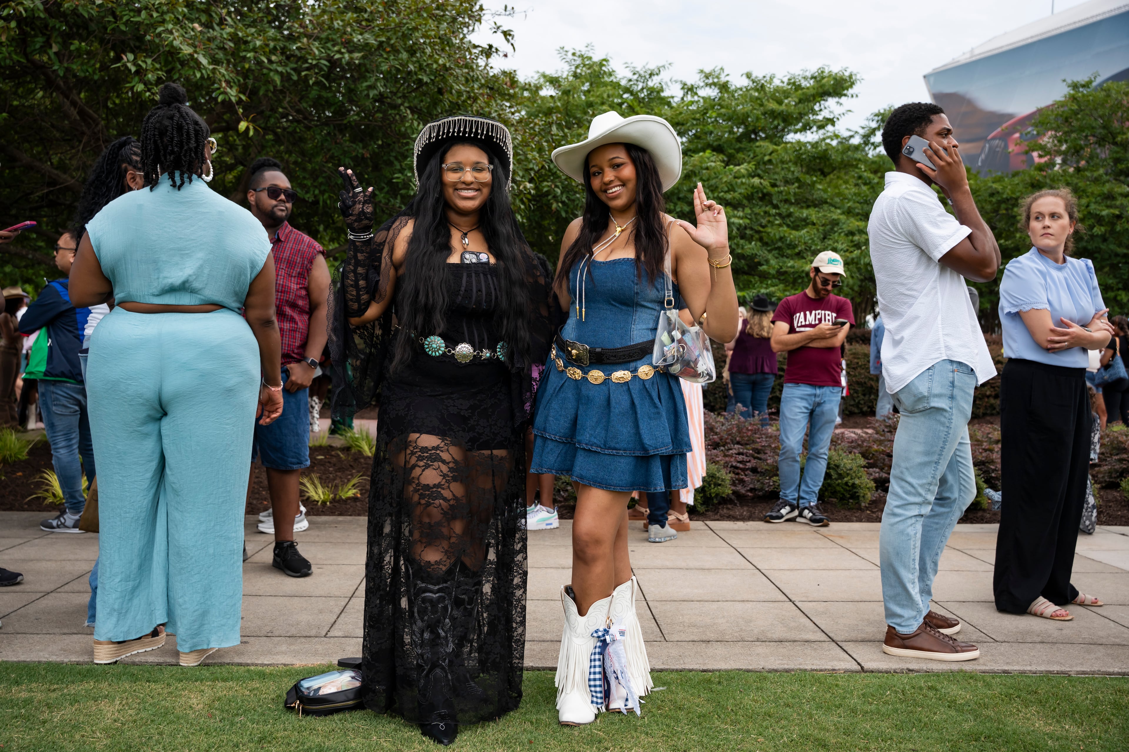 Karrigan Turner (left) and Mia Griffin pose in line at Beyoncé's Cowboy Carter concert in Atlanta on Thursday, July 10, 2025. (Olivia Bowdoin for the AJC)