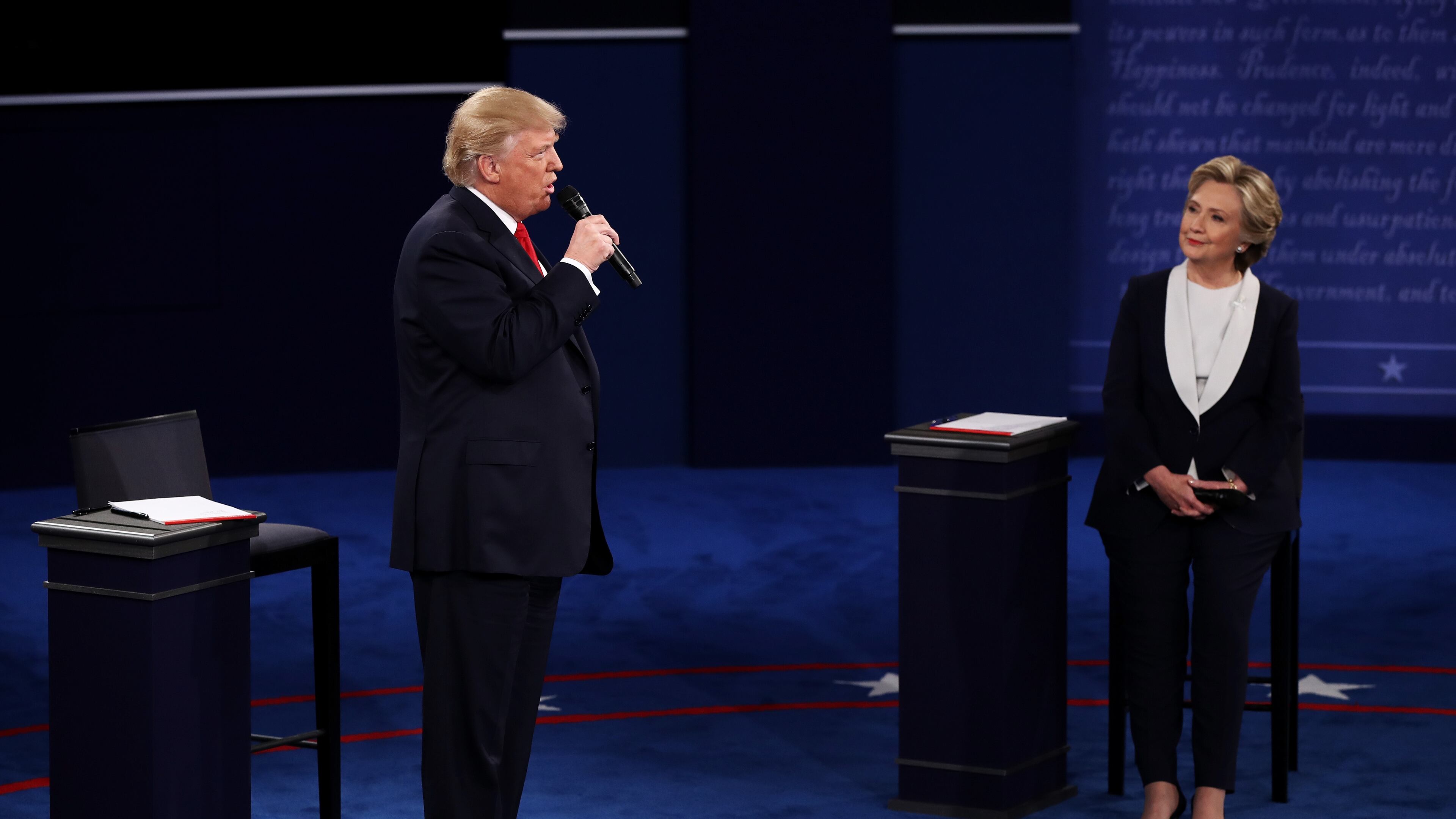 ST LOUIS, MO - OCTOBER 09: Republican presidential nominee Donald Trump (L) speaks as Democratic presidential nominee former Secretary of State Hillary Clinton listens during the town hall debate at Washington University on October 9, 2016 in St Louis, Missouri. This is the second of three presidential debates scheduled prior to the November 8th election. (Photo by Win McNamee/Getty Images)