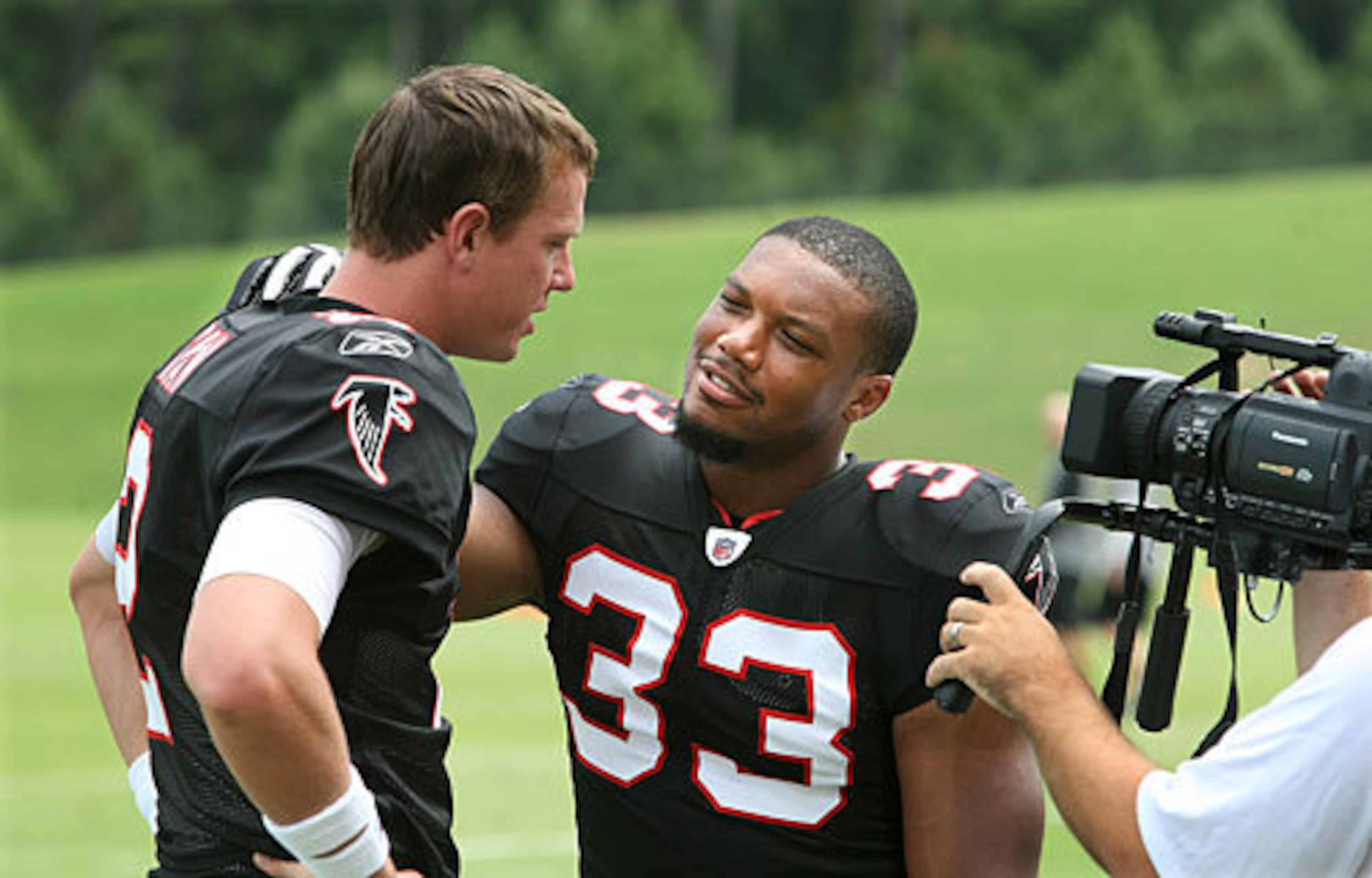 LIGHTS... THROWBACKS... ACTION! Ryan and Turner film their part of a video promoting the throwback uniform games.