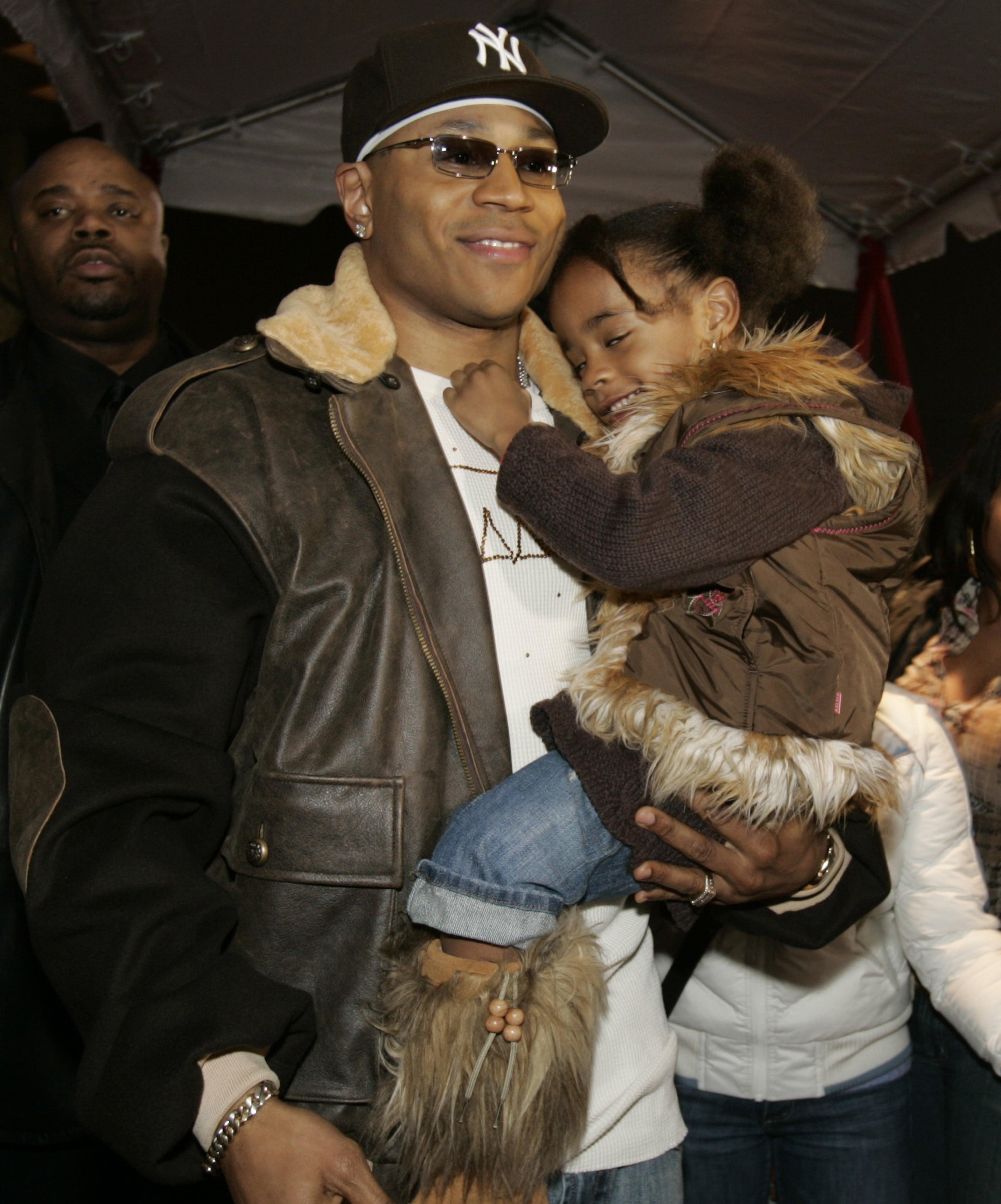 LL Cool J holds his daughter, Nina, outside the New Jersey premiere of his new film, "Last Holiday" in Newark, N.J., Wednesday, Jan. 11, 2006. LL Cool J co-stars with Queen Latifah, who grew up in Newark, in the new comedy. (AP Photo/Mike Derer)