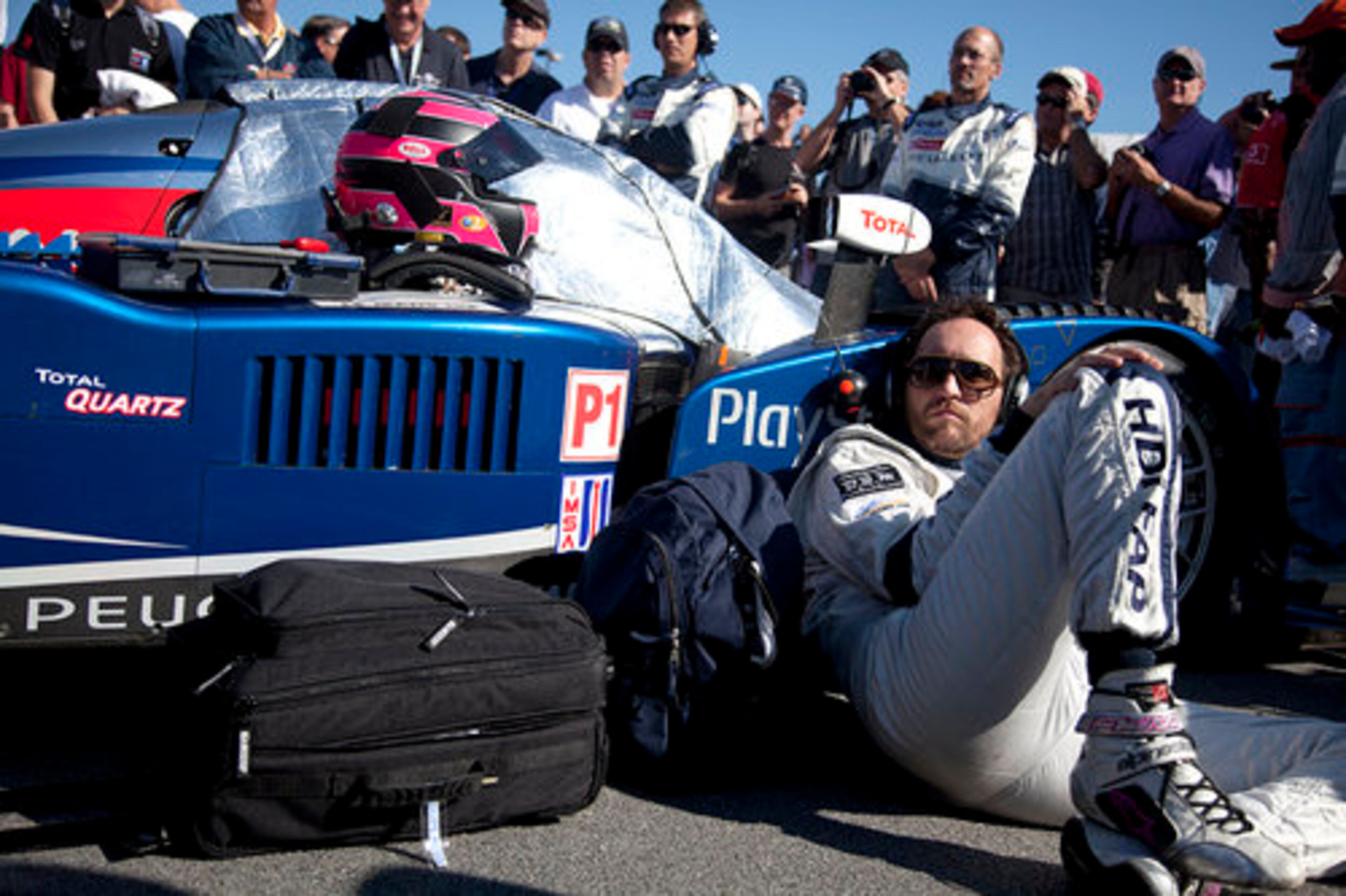 Team Peugeot Total driver Franck Montagny relaxes to some tunes alongside his #08 Peugeot 908 HDI FAP before taking to the 2.54-mile track.