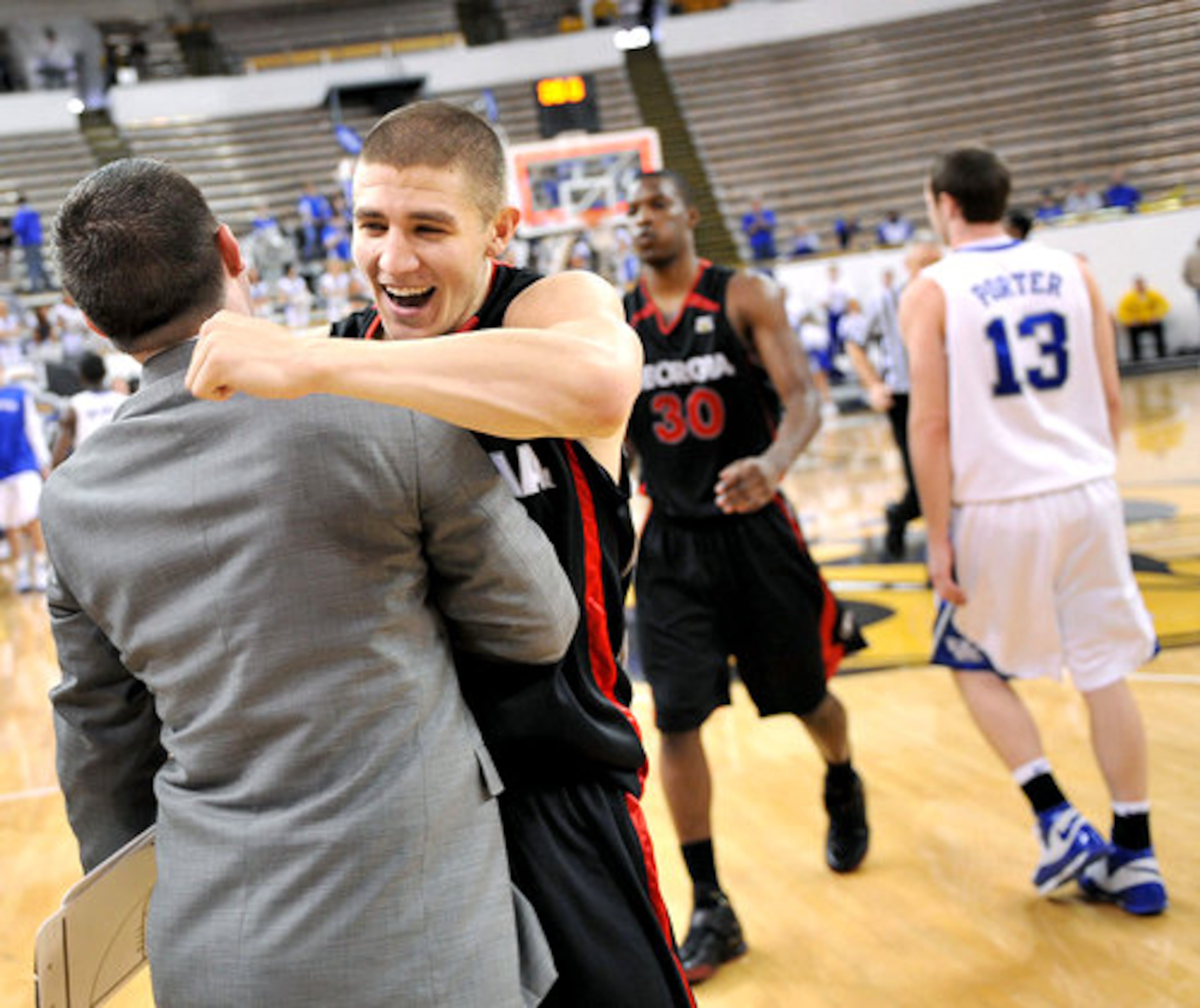 Swansey hugs teammates during the celebration after their win during the last second of the games.