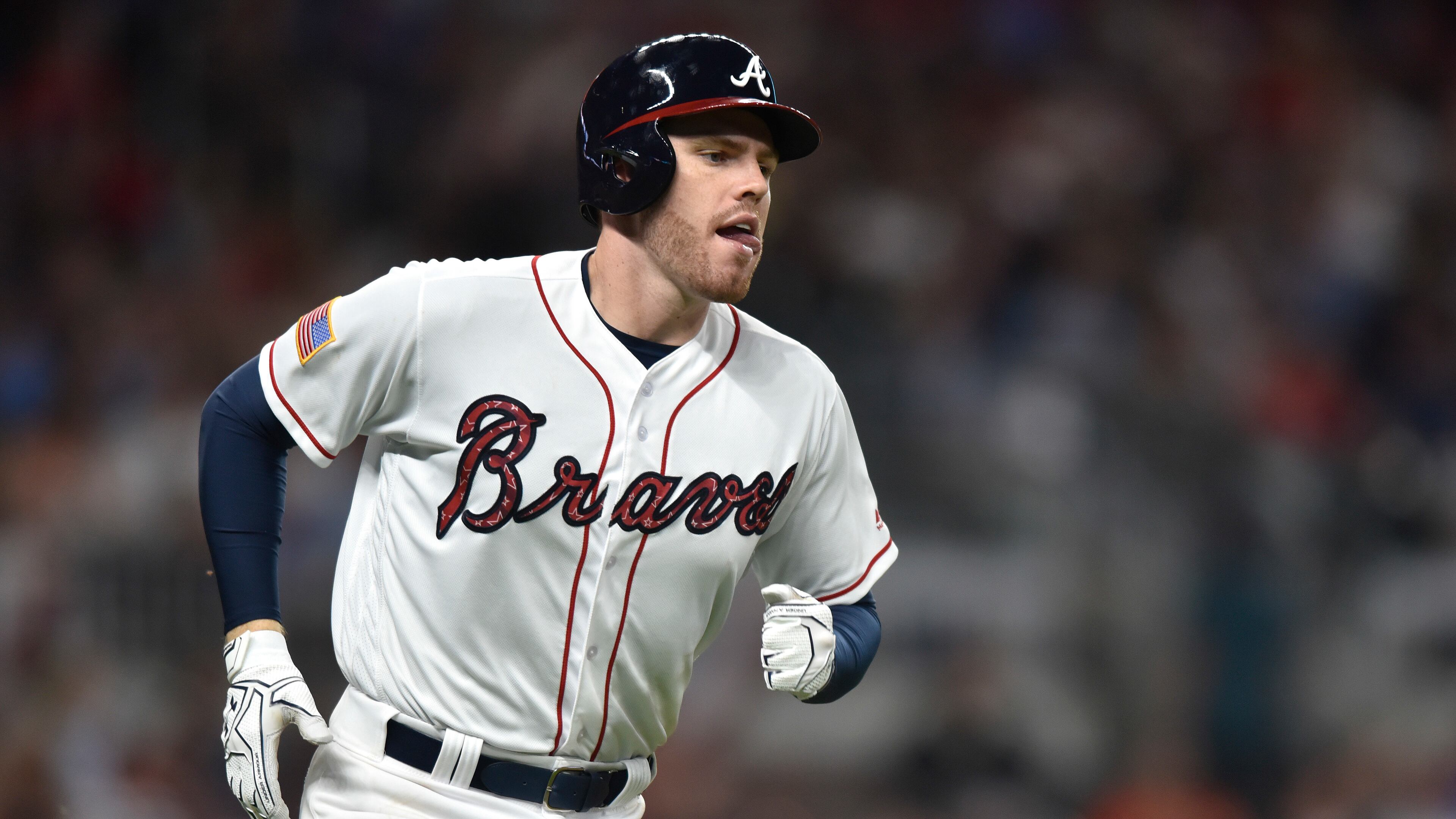 Atlanta Braves third baseman Freddie Freeman runs to first base during the fourth inning of a baseball game against the Houston Astros, Tuesday, July 4, 2017, in Atlanta. (AP Photo/Richard Hamm)