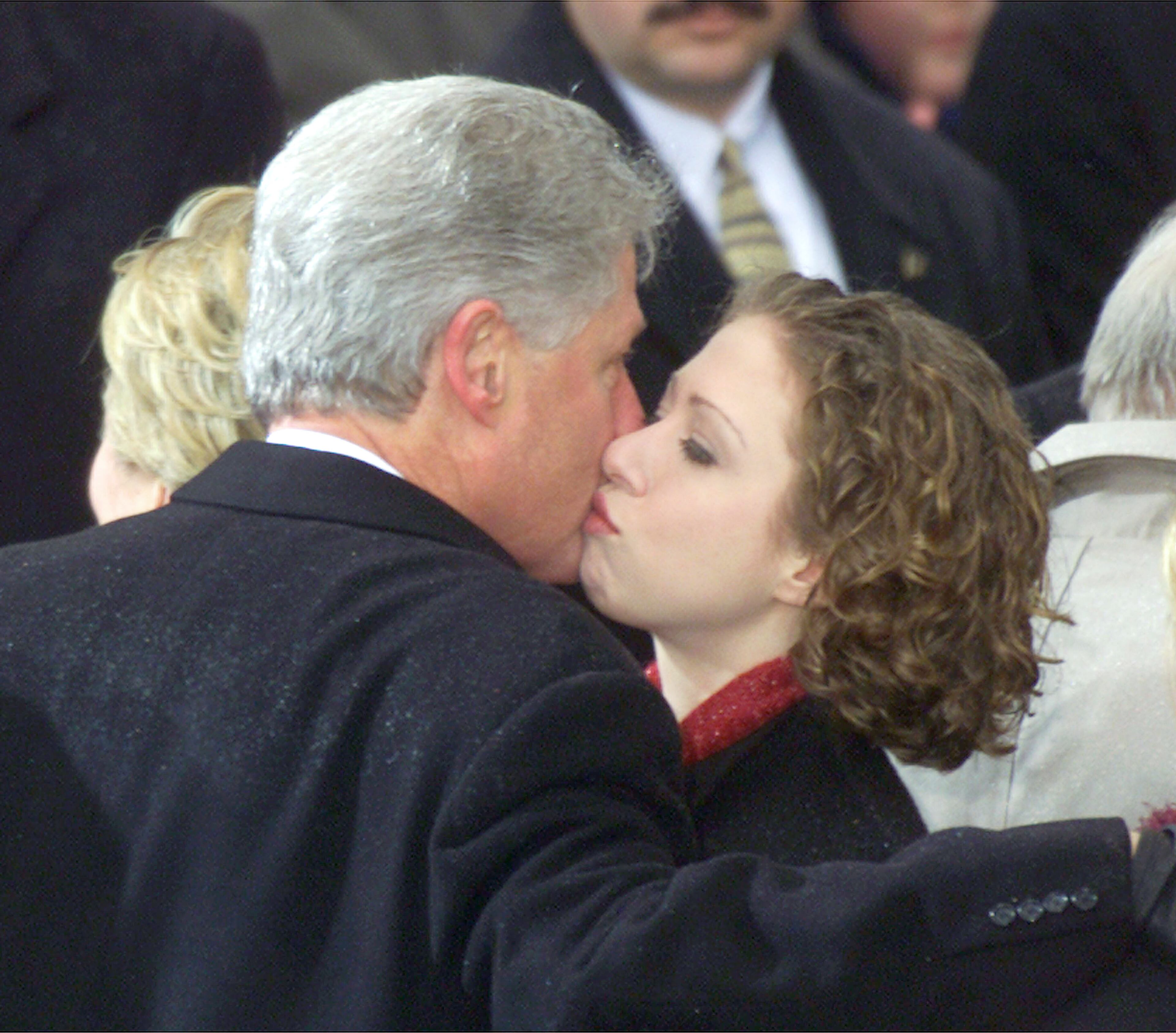 Chelsea Clinton gives her father a kiss after George W. Bush was sworn in as 43rd President of the United States by Supreme Court Chief Justice William Rehnquist January 20, 2001 outside the U.S. Capitol building in Washington. (Photo by Mark Wilson/Newsmakers)