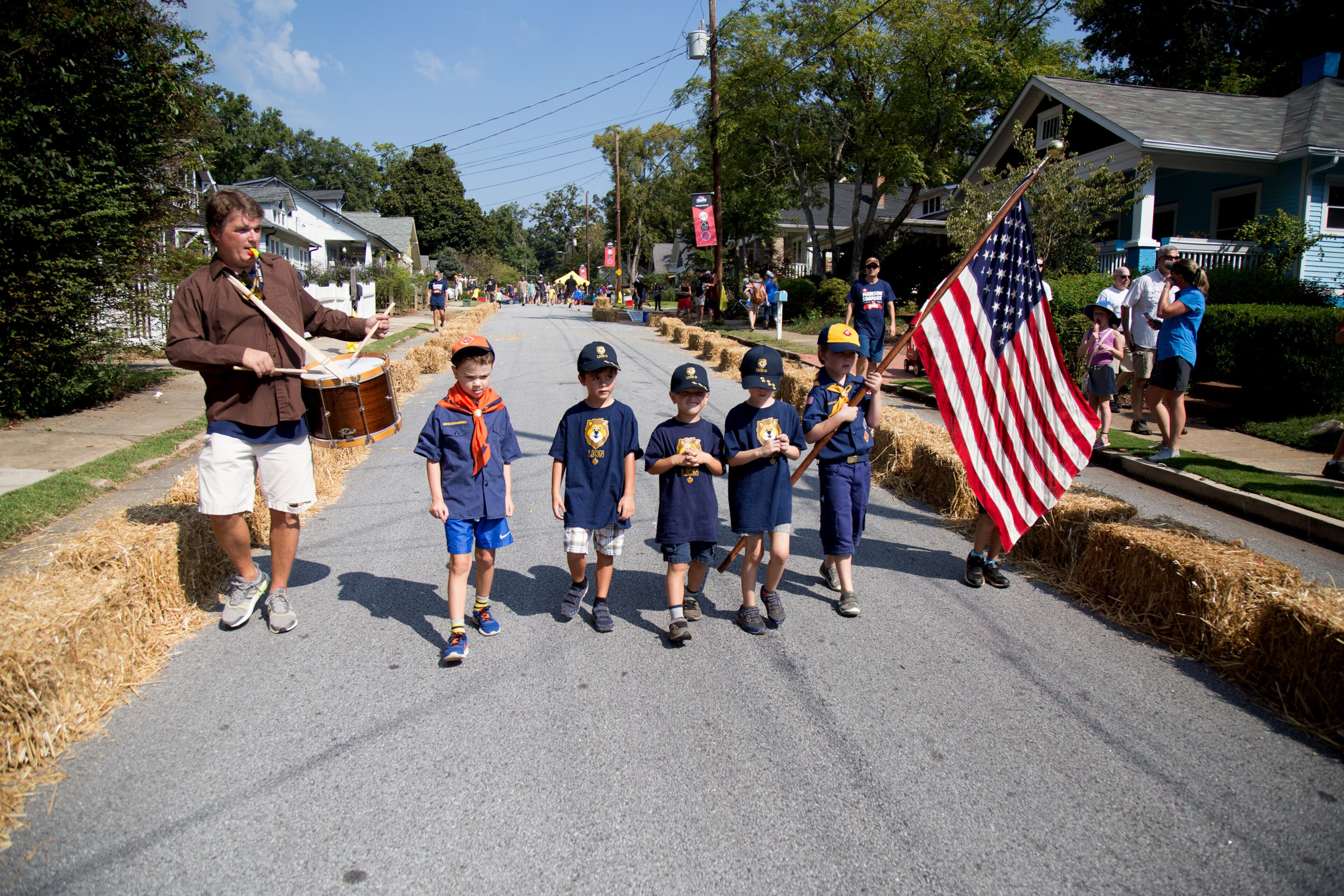 Kevin Leahy (L) plays the drums as the Decatur Cub Scouts Pack 134 brings the American flag down the street before the start of the 8th Annual Madison Avenue Soapbox Derby, October 6, 2018. Started in 2011 the Madison Avenue Soapbox Derby has raised nearly $130,000 for local charities. STEVE SCHAEFER / SPECIAL TO THE AJC