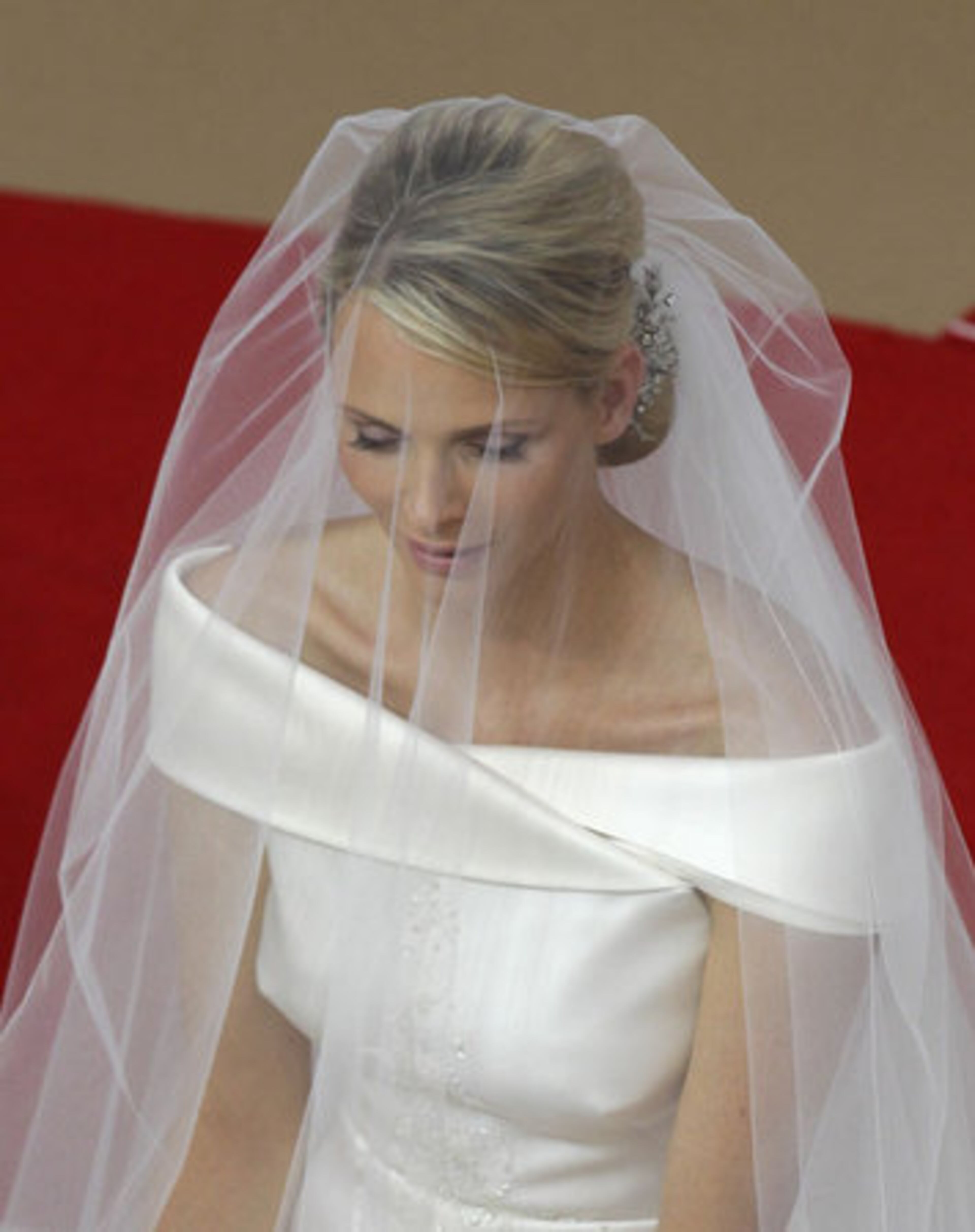 Charlene Princess of Monaco wore a simple white, off-the-shoulder gown on her wedding day.