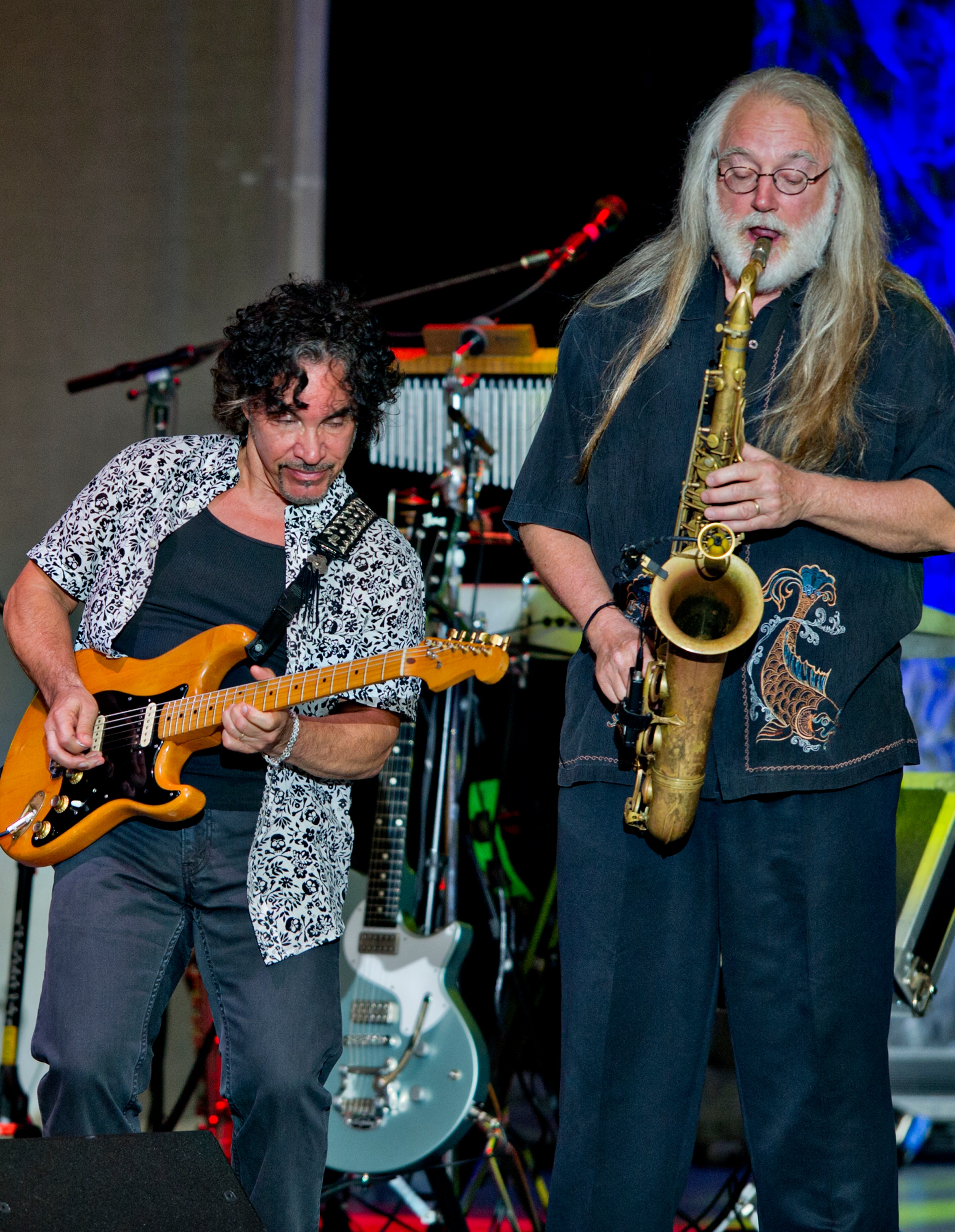 John Oates (left) plays with saxophonist Charlie DeChant Sunday, June 15, 2014 at Chastain Park Amphitheatre in Atlanta. JONATHAN PHILLIPS / SPECIAL