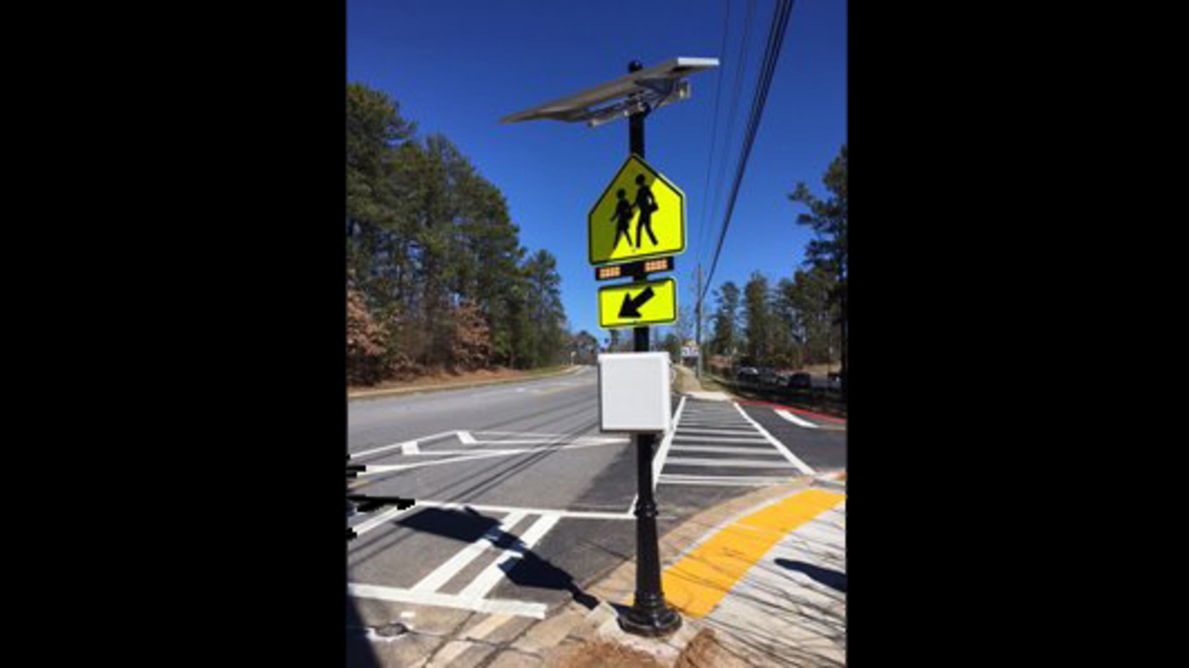 A new crosswalk on Buice Road in Johns Creek features the city’s first “Rectangular Rapid Flashing Beacons” to warn motorists of pedestrians crossing. CITY OF JOHNS CREEK