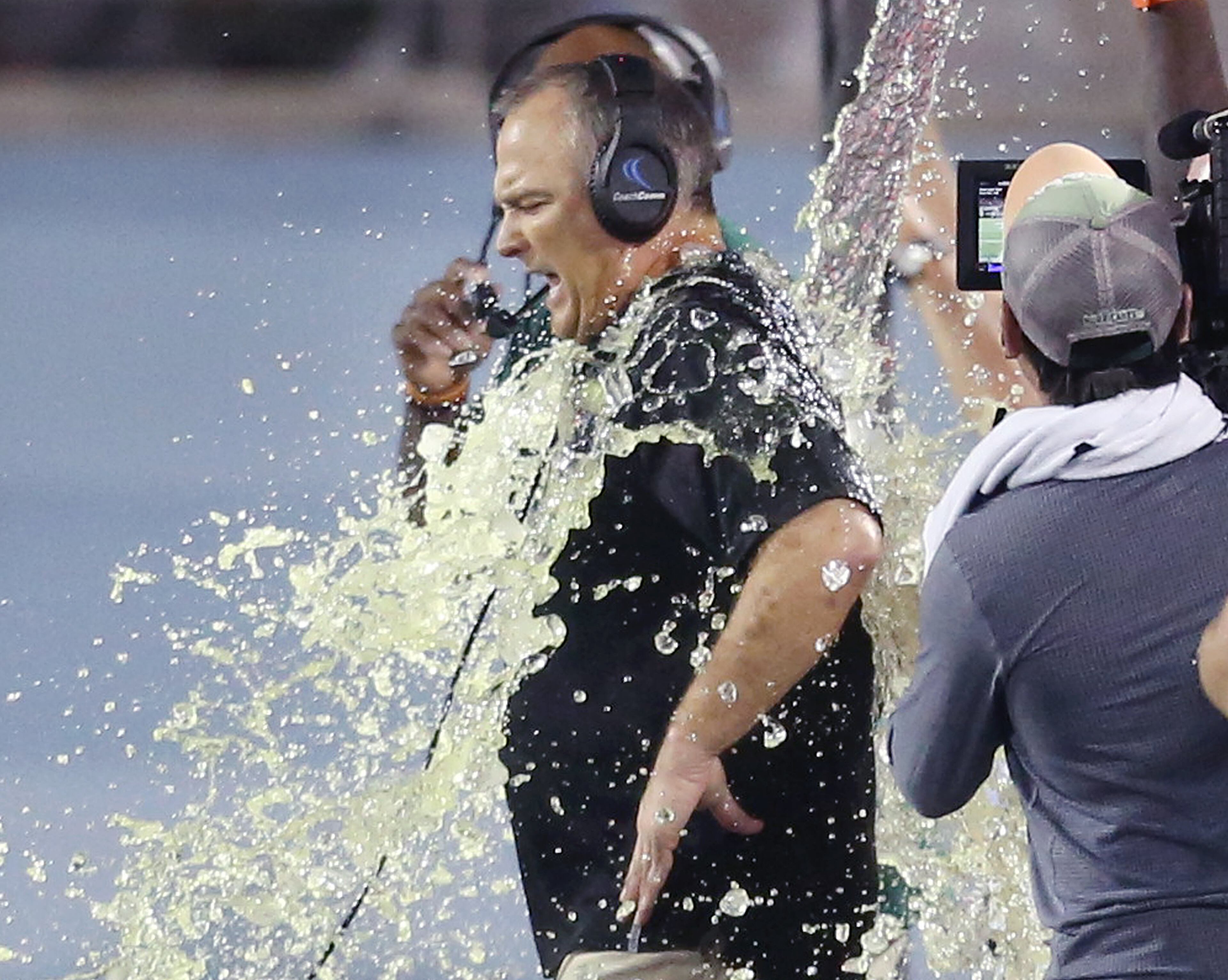 Miami head coach Mark Richt is showered with Gatorade after winning the Russell Athletic Bowl game of Miami against West Virginia, 31-14, at Camping World Stadium in Orlando, Fla., on Wednesday, Dec. 28, 2016. (Stephen M. Dowell/Orlando Sentinel/TNS)