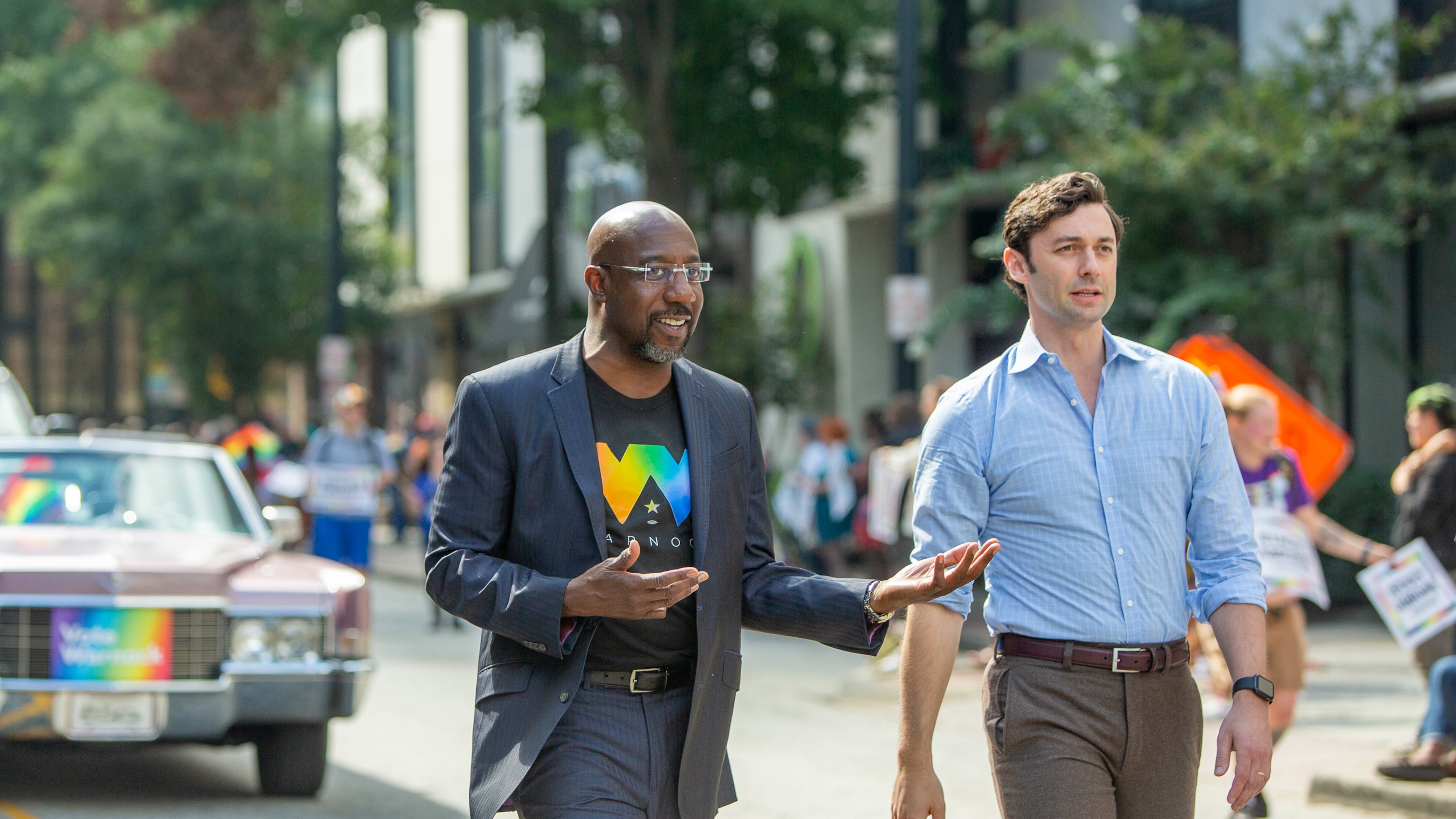 U.S. Sens. Raphael Warnock, left, and Jon Ossoff, shown participating in October in Atlanta's Pride Parade, voted in favor of advancing a bill to create a federal law protecting the rights of consenting adults to wed. (Jenni Girtman for The Atlanta Journal-Constitution)