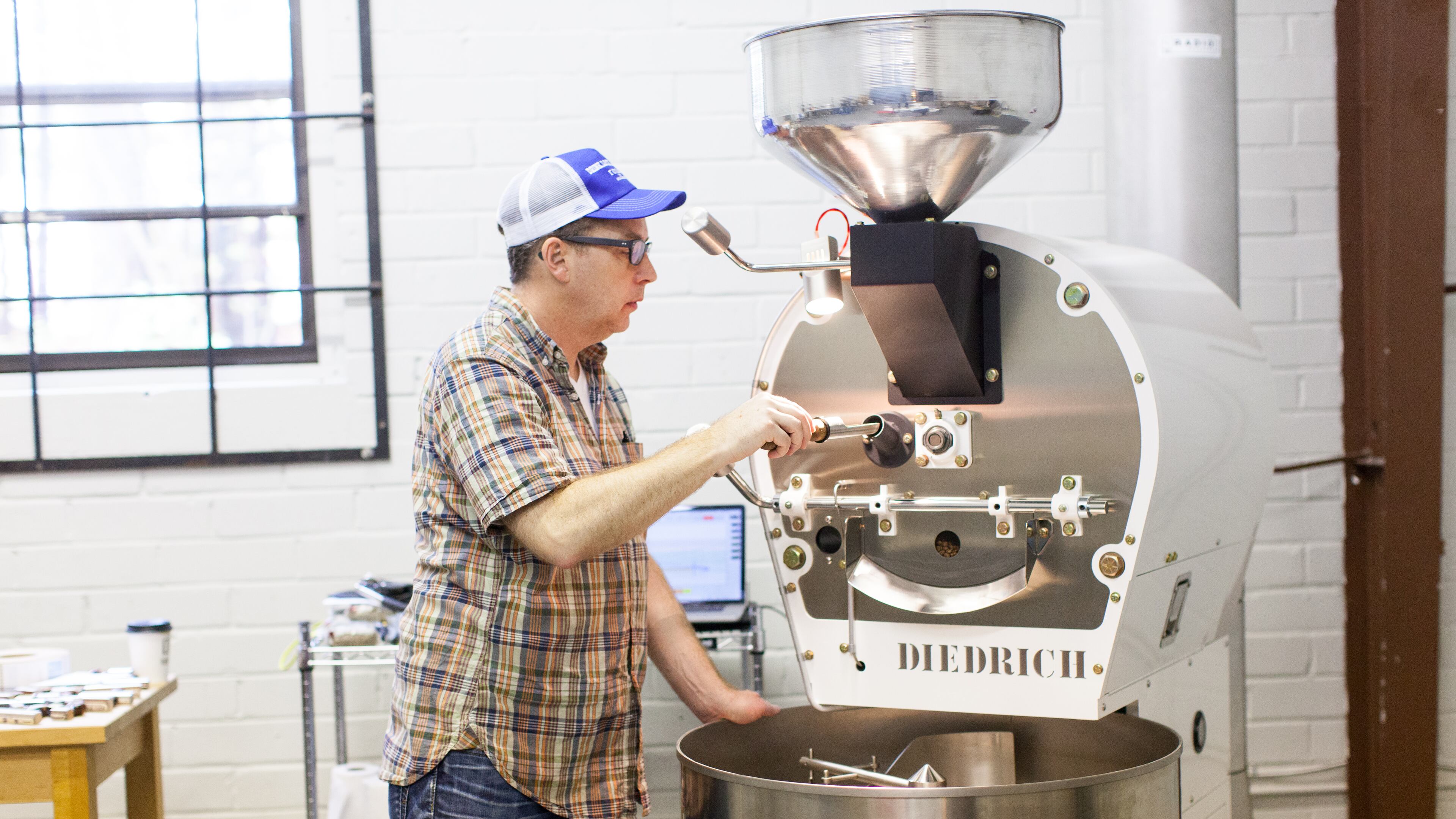 Radio Roasters owner Chip Grabow prepping a coffee order for one of their wholesale partners. (Photo credit: Whitney Ott)