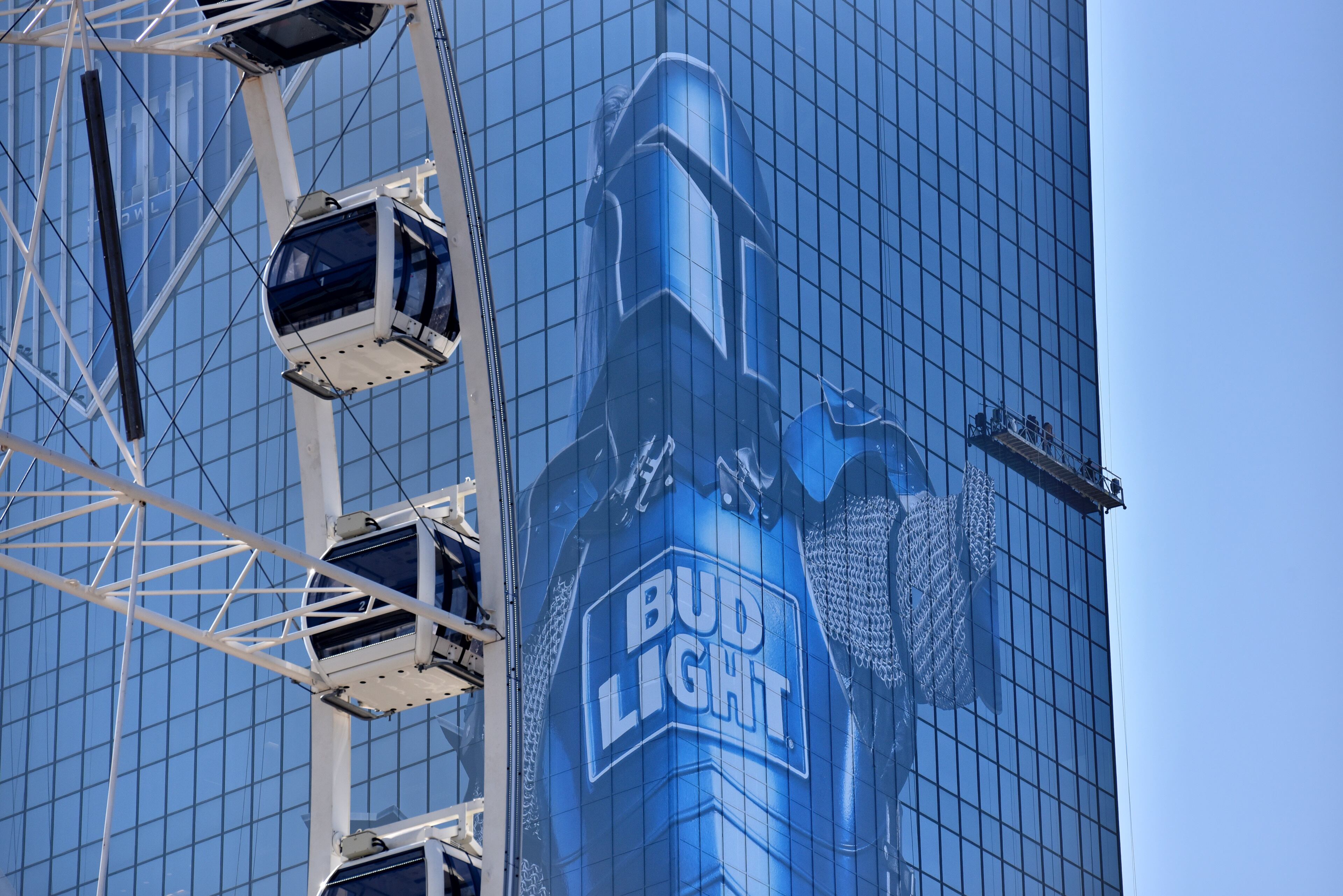 January 16, 2019 Atlanta - Workers install Bud Light advertising on 101 Marietta Street on Wednesday, January 16, 2019. Atlanta faces a test on Super Bowl Sunday and the question with less than a month to go before the big game is this: Is the city ready? The city budgeted some $10 million last year for police, fire and other items to assist with the big game. HYOSUB SHIN / HSHIN@AJC.COM