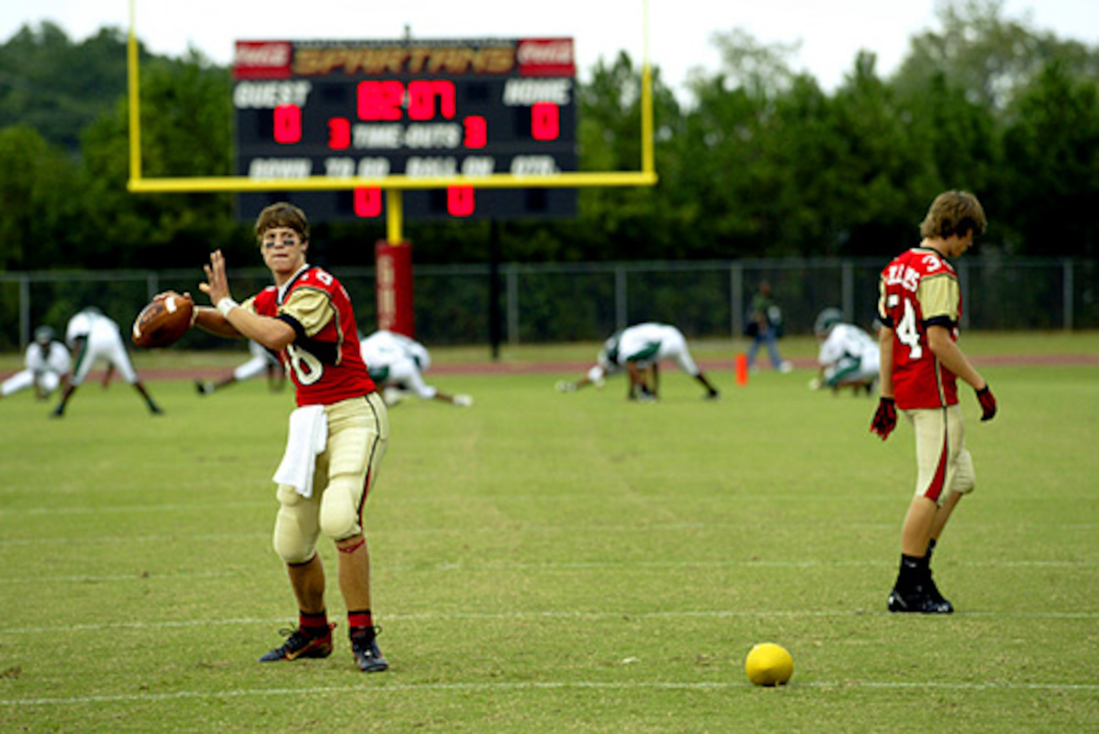 Greater Atlanta Christian School's starting quarterback Colton Chapple warms up by throwing the ball to his teammates during a drill before their game against Cross Keys High School.